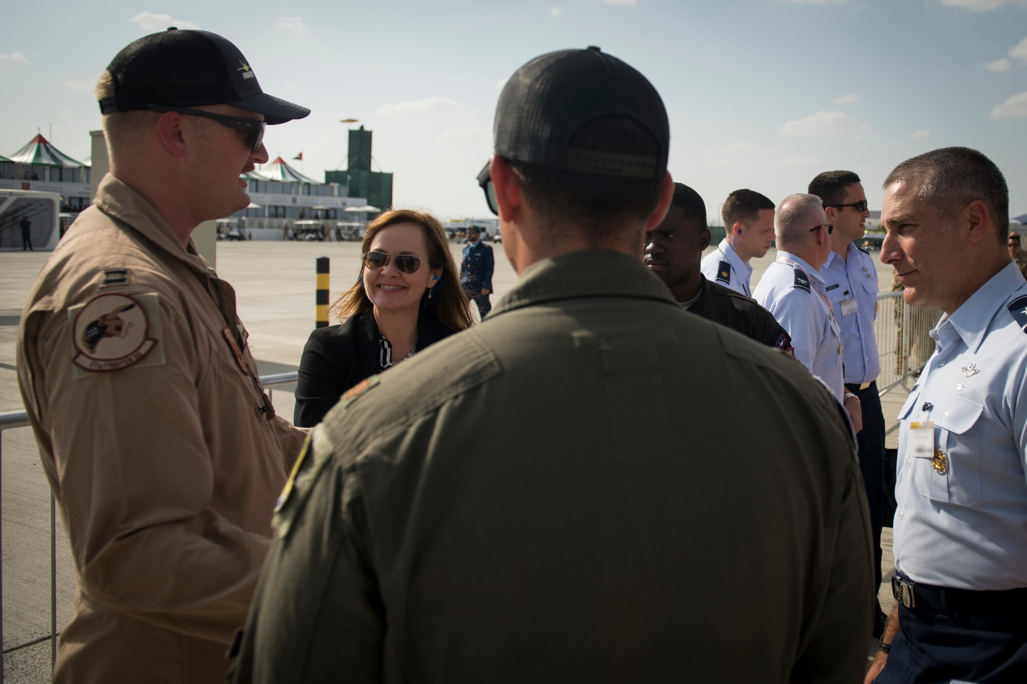 Kelli Seybolt, second from left, the Deputy Under Secretary of the Air Force, International Affairs, discusses F-22 Raptor capabilities with U.S. Air Force Capt. Keenan Bell, an F-22 Raptor pilot with the 27th Fighter Squadron at Joint Base Langley-Eustis, Va., as part of the Dubai Airshow, United Arab Emirates, on Nov. 18, 2019.