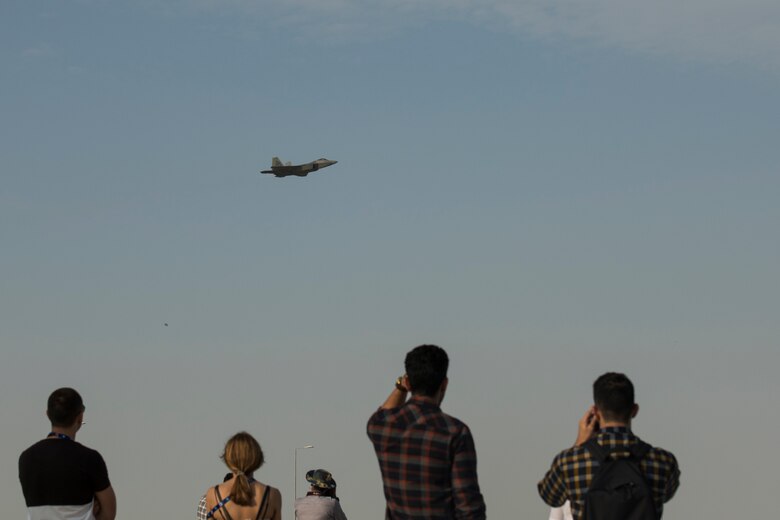 Spectators look on as a U.S. Air Force F-22 Raptor performs an aerial demonstration at the Dubai Airshow, Nov. 19, 2019.