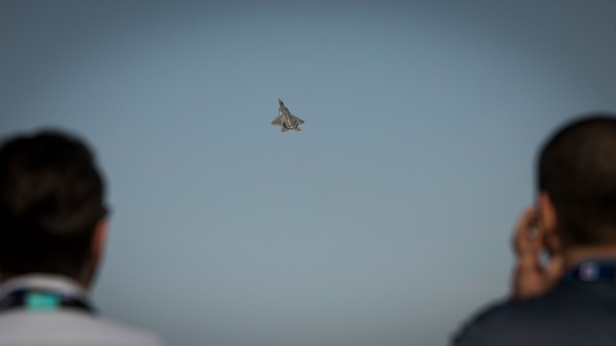 Spectators look on as a U.S. Air Force F-22 Raptor performs an aerial demonstration at the Dubai Airshow, Nov. 19, 2019.