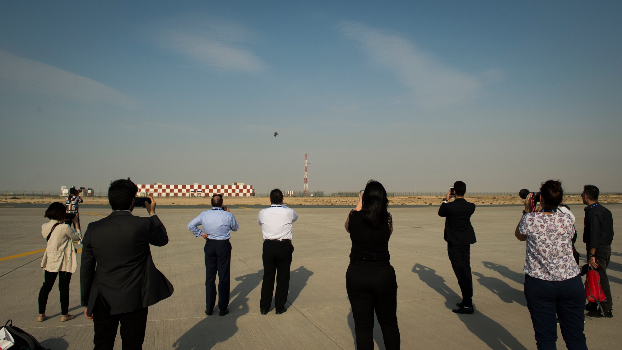 Spectators look on as a U.S. Air Force F-22 Raptor performs an aerial demonstration at the Dubai Airshow, Nov. 19, 2019.