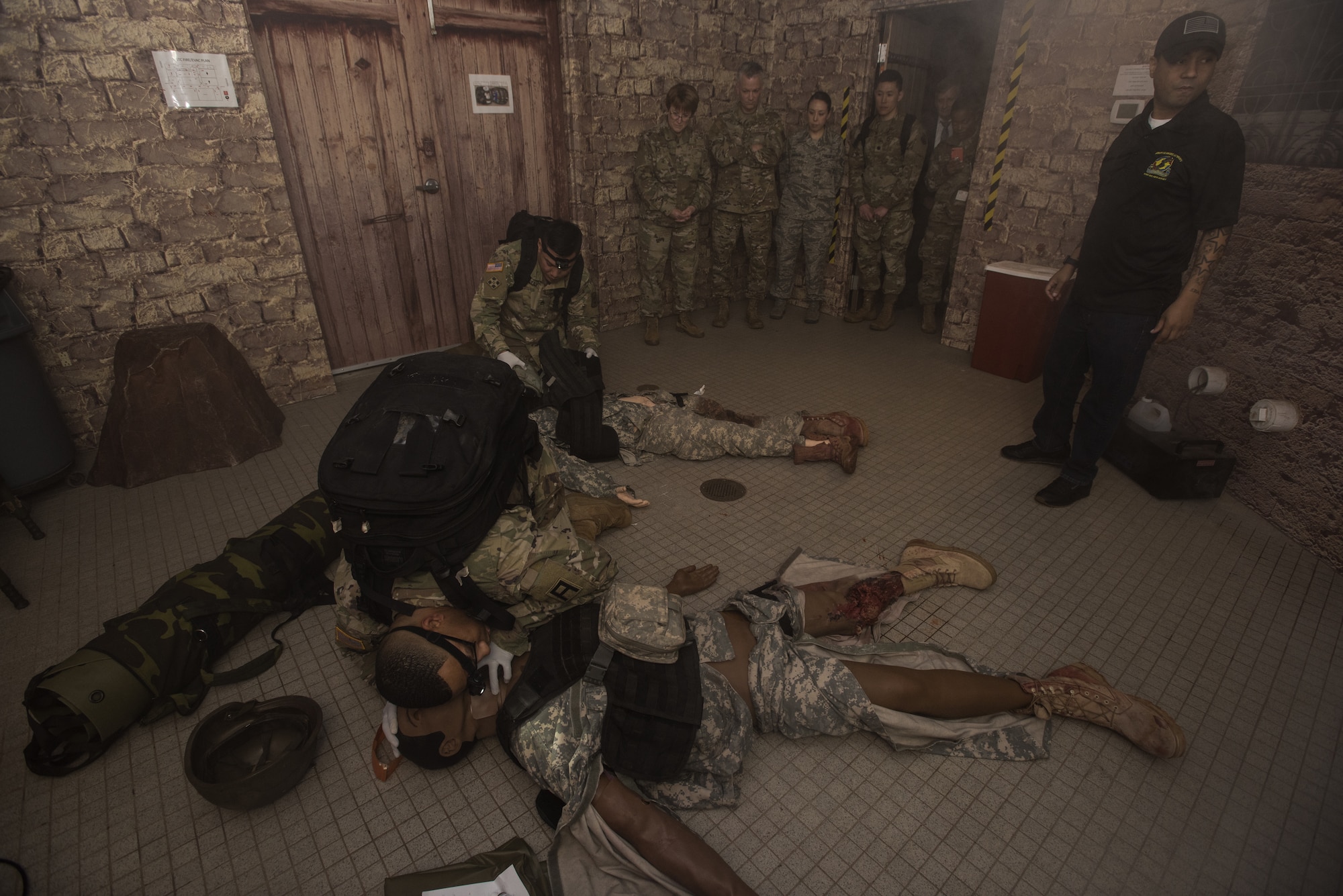 U.S. Air Force Medical Service leadership watch a simulated medical emergency in a simulated hostile environment during a tour at Joint Base McGuire-Dix-Lakehurst, N.J., Nov. 21, 2019. Lt. Gen. Dorothy Hogg, U.S. Air Force Surgeon General, and Chief Master Sgt. G. Steve Cum, Chief of the Medical Enlisted Force, toured the 87th Medical Group to grasp a better understanding of how an Air Force run medical facility provides care to all five sister services within the only tri-service installation. Hogg and Cum were shown the Air Force’s only fully equipped medical simulation facility. (U.S. Air Force photo by Airman 1st Class Ariel Owings)
