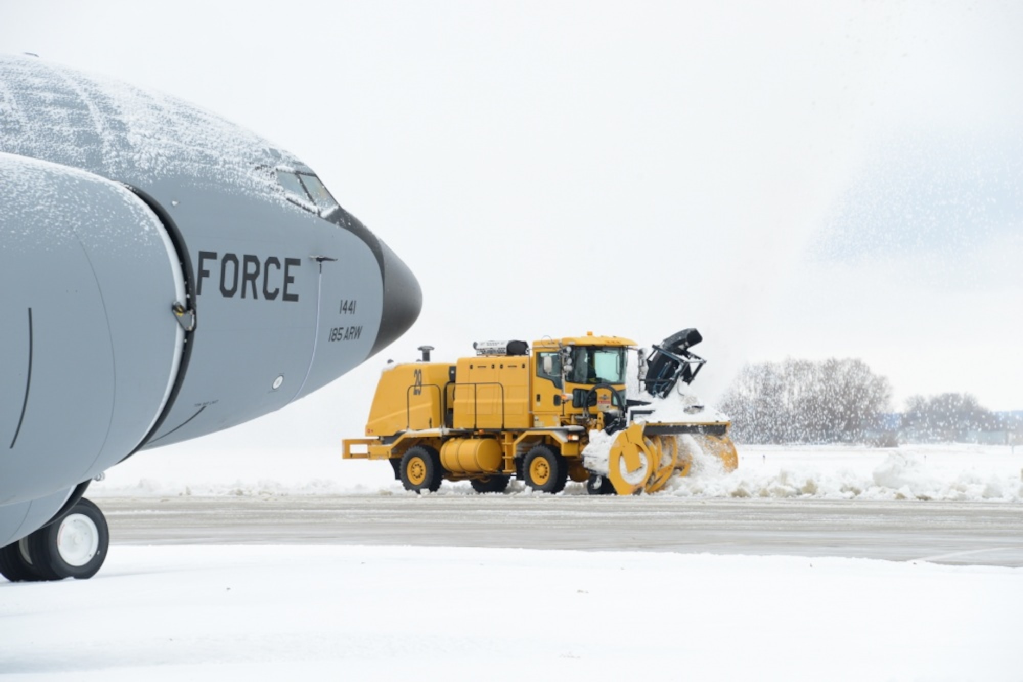 A member of the snow removal team assigned to the 185th Air Refueling Wing, Iowa Air National Guard, clears snow on the ramp in Sioux City, Iowa, Nov. 27, 2019. (Photo by Senior Master Sgt. Vincent De Groot)