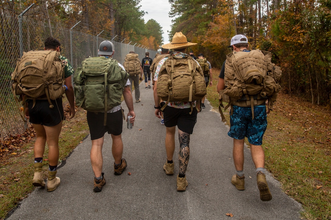 U.S. Marines and Sailors with 2nd Reconnaissance Battalion, 2nd Marine Division participate in charity ruck march in Jacksonville, North Carolina, Nov. 27, 2019. The Marines hiked from the Camp Lejeune main gate to the United Way's Children Healthy Eating on the Weekend house. The march supports CHEW! program which provides underprivileged children with donated food every weekend.