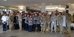 DLA Troop Support Commander Army Brig. Gen. Gavin Lawrence, far right, poses with senior leaders assigned to the 87th Force Support Squadron, Joint Basie McGuire-Dix-Lakehurst, and dining facility staff pose for a photo, before serving the traditional Thanksgiving meal Nov. 28, 2019, at the Halverson Hall Dining Facility, Joint Base McGuire-Dix-Lakehurst, New Jersey. The staff of the Halverson Hall Dining Facility provided the traditional Thanksgiving meal for airmen and their families who were away from home for the holiday. (Photo by Alexandria Brimage-Gray)