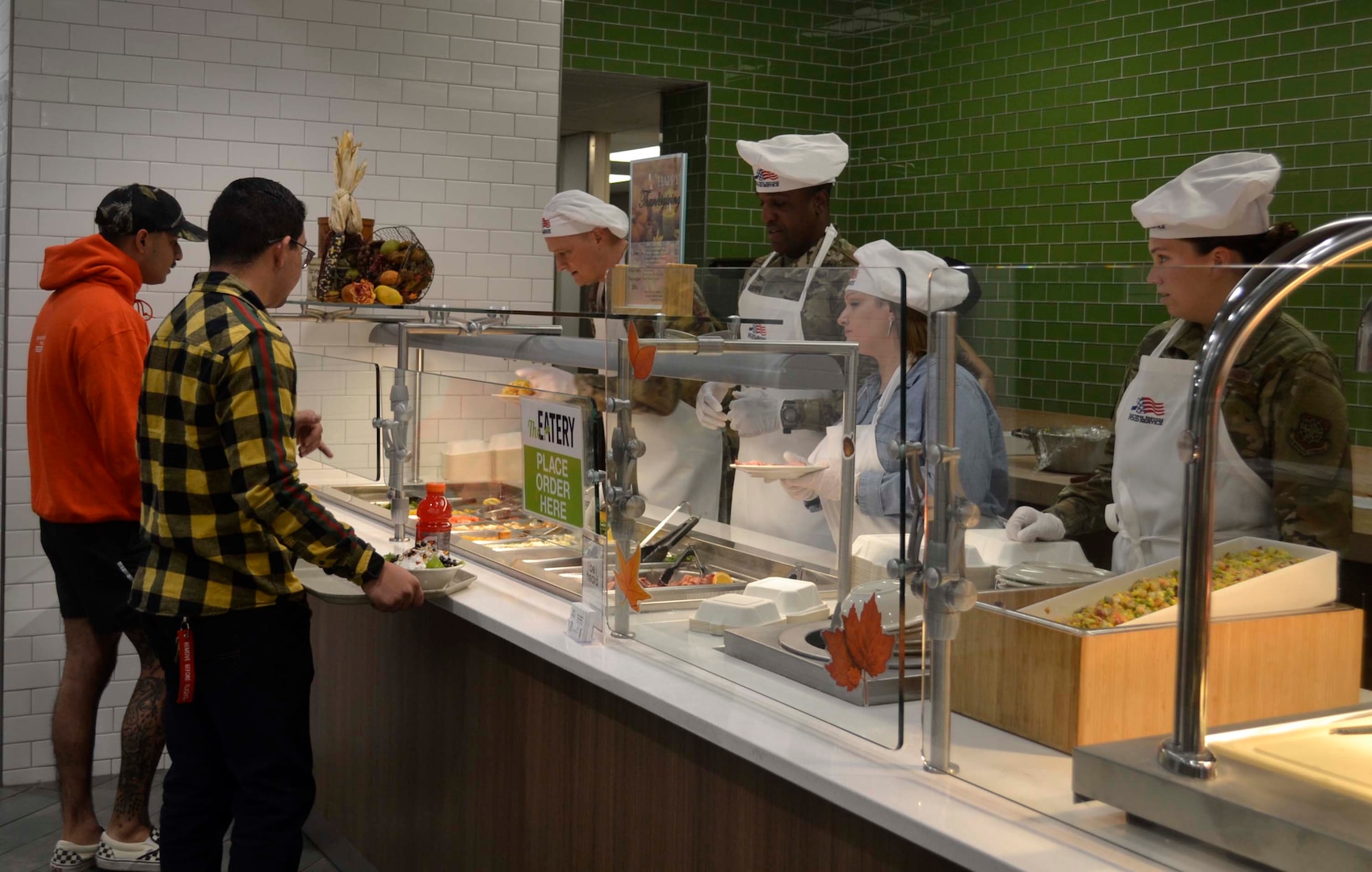 Army Brig. Gen. Gavin Lawrence, DLA Troop Support commander, third from right, serves two airmen a traditional Thanksgiving meal, Nov. 28, 2019, at the Halverson Hall Dining Facility, Joint Base McGuire-Dix-Lakehurst, New Jersey. Lawrence, along with senior leaders assigned to the 87th Force Support Squadron and their spouses, served meals to airmen and their families who were away from home for the holiday. (Photo by Alexandria Brimage-Gray)