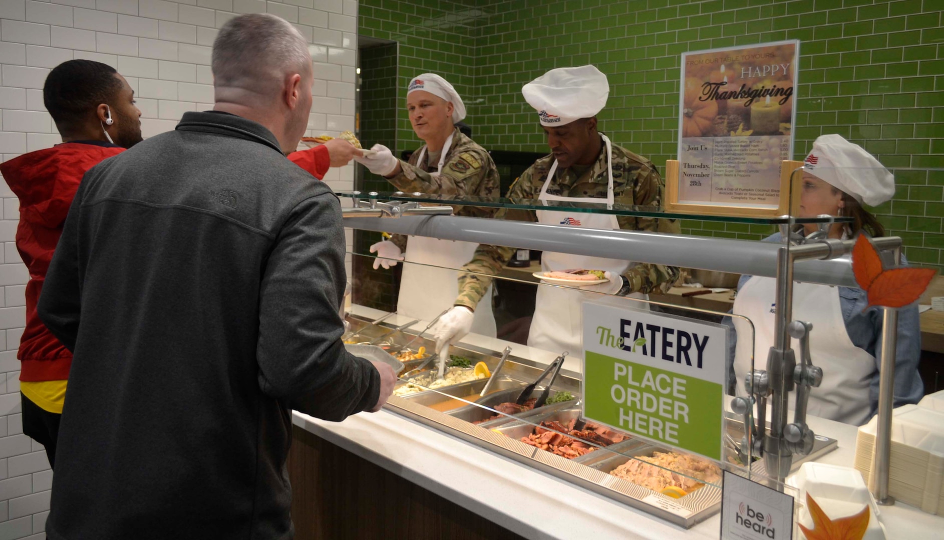 Army Brig. Gen. Gavin Lawrence, DLA Troop Support commander, second from right, serves two airmen a traditional Thanksgiving meal, Nov. 28, 2019, at the Halverson Hall Dining Facility, Joint Base McGuire-Dix-Lakehurst, New Jersey. Lawrence, along with senior leaders assigned to the 87th Force Support Squadron and their spouses, served meals to airmen and their families who were away from home for the holiday. (Photo by Alexandria Brimage-Gray)