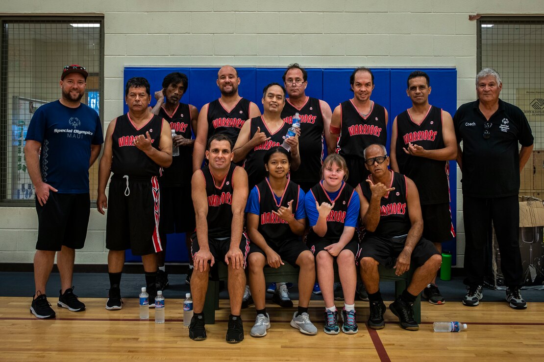 Participants and their coaches pose for a group picture during the Special Olympics Hawaii Holiday Classic State Games, Marine Corps Base Hawaii, Nov. 23, 2019. SOHI provides sports training throughout the year and athletic competition in a variety of Olympic sports for persons with intellectual or development disabilities. MCBH began supporting the SOHI event in 1997.