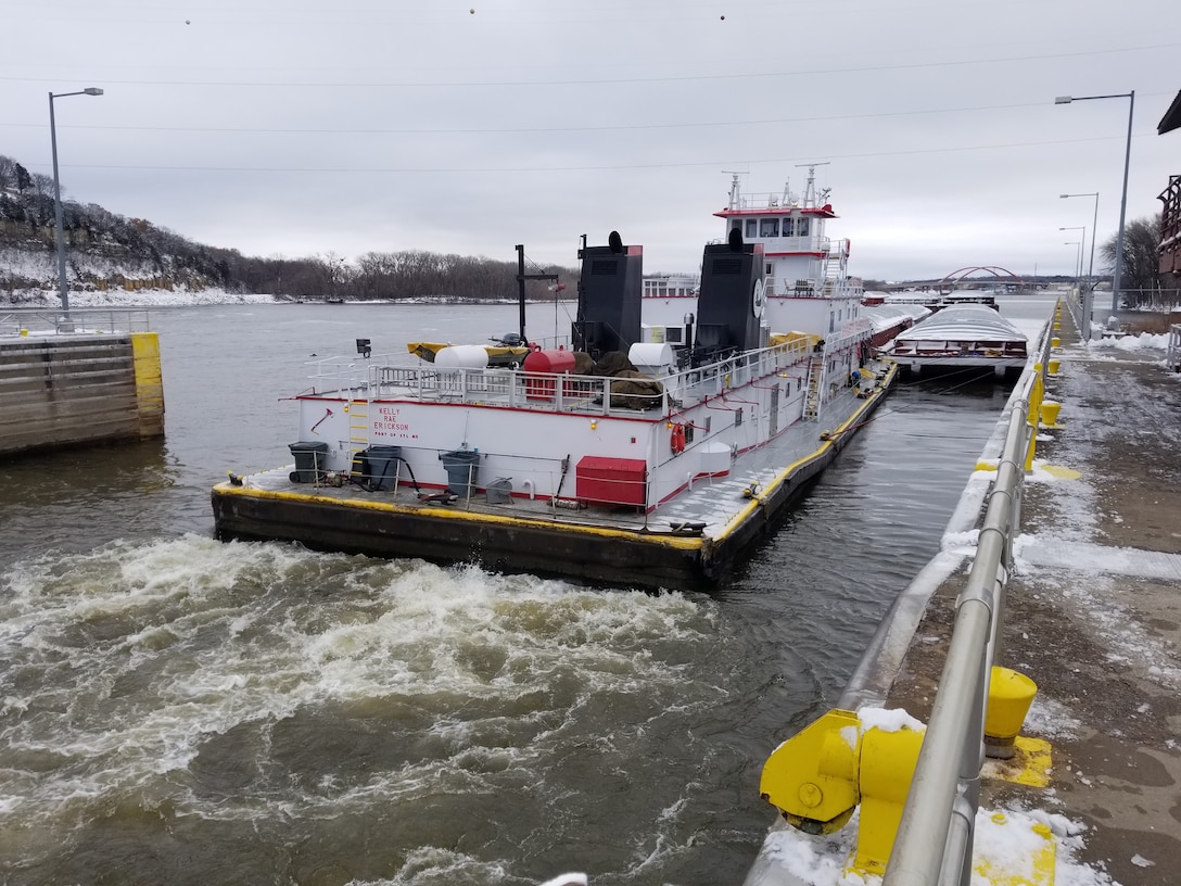 Tow boat departing a lock chamber