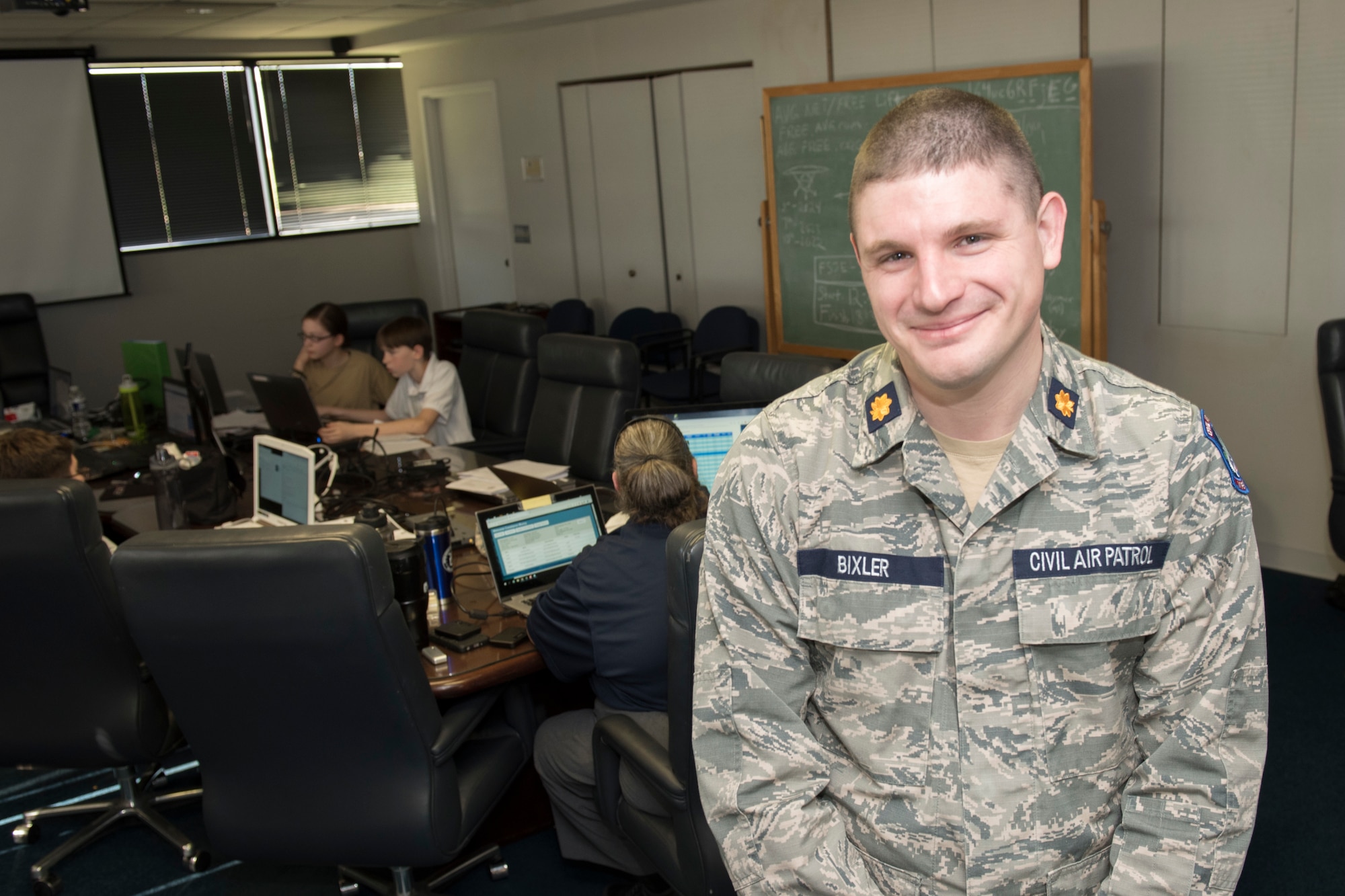 Civil Air Patrol Maj. Jacob Bixler, the Wing Director of Cadet Programs for Virginia Wing, CAP, stands in the conference room at the Winchester Regional Airport, as cadets participate in the CyberPatriot Competition, Oct. 27, 2019.  Bixler is also a technical sergeant in the 167th Airlift Wing, West Virginia Air National Guard, serving as a radio frequency transmissions systems craftsman.