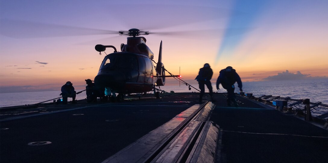 Crewmembers of the Coast Guard Cutter Mohawk conduct night helicopter tie-down operations.