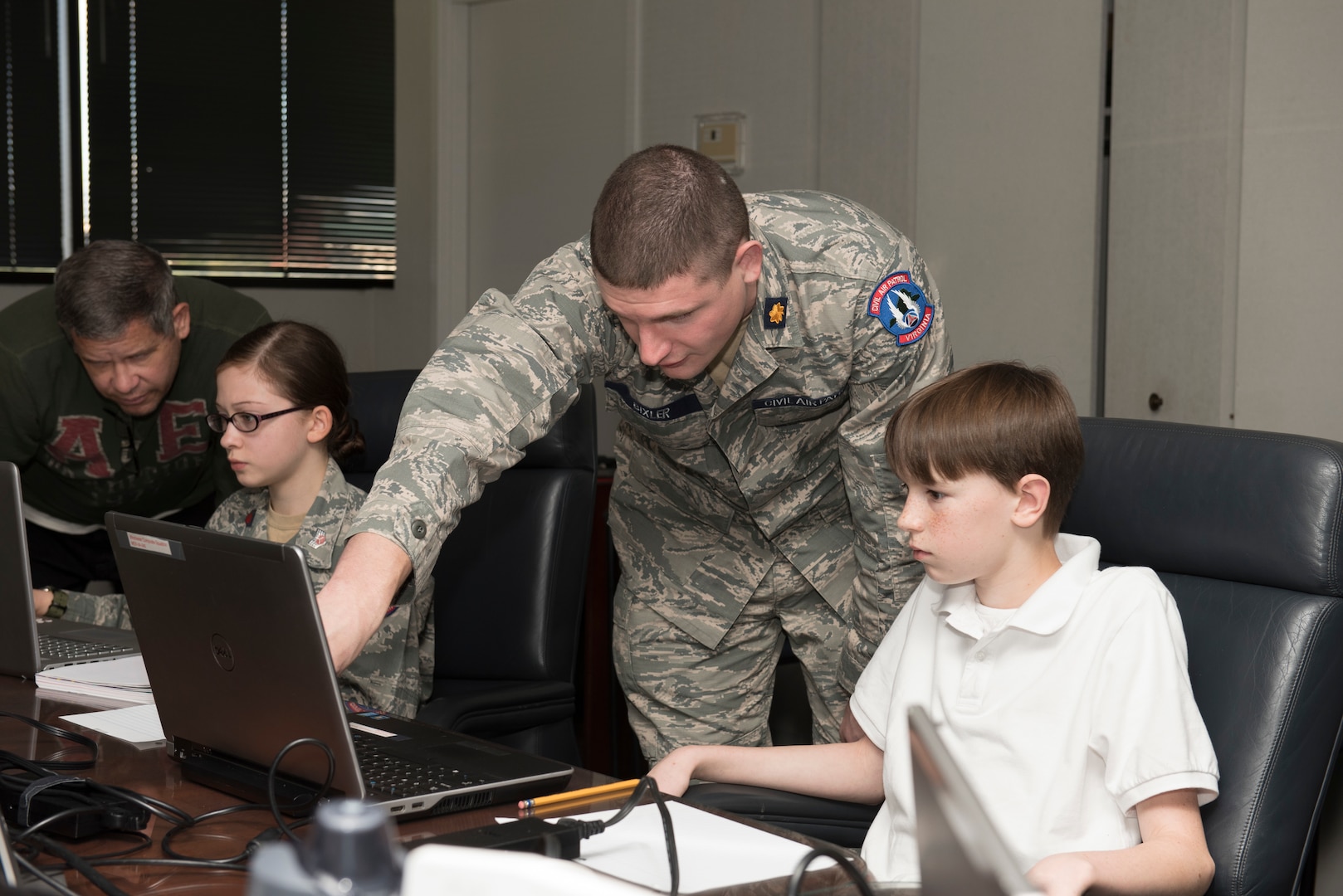 Civil Air Patrol Maj. Jacob Bixler, the Wing Director of Cadet Programs for Virginia Wing, CAP, assists CAP cadets before the start of the CyberPatriot Competition, Oct. 27, 2019.  Bixler is also a radio frequency transmissions systems craftsman for the 167th AW.