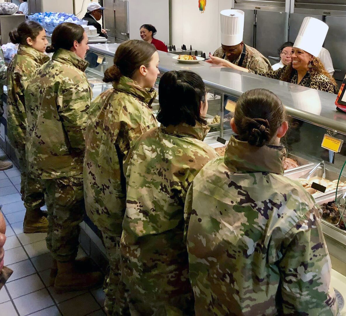 Col. Devin R. Pepper (on line, center), commander, 460th Space Wing, Buckley Air Force Base, Colorado, helps dish out Thanksgiving meals to Airmen in basic training at Joint Base San Antonio-Lackland Nov. 28. Pepper served as the reviewing official at the Air Force Basic Military Training parade Nov. 29.