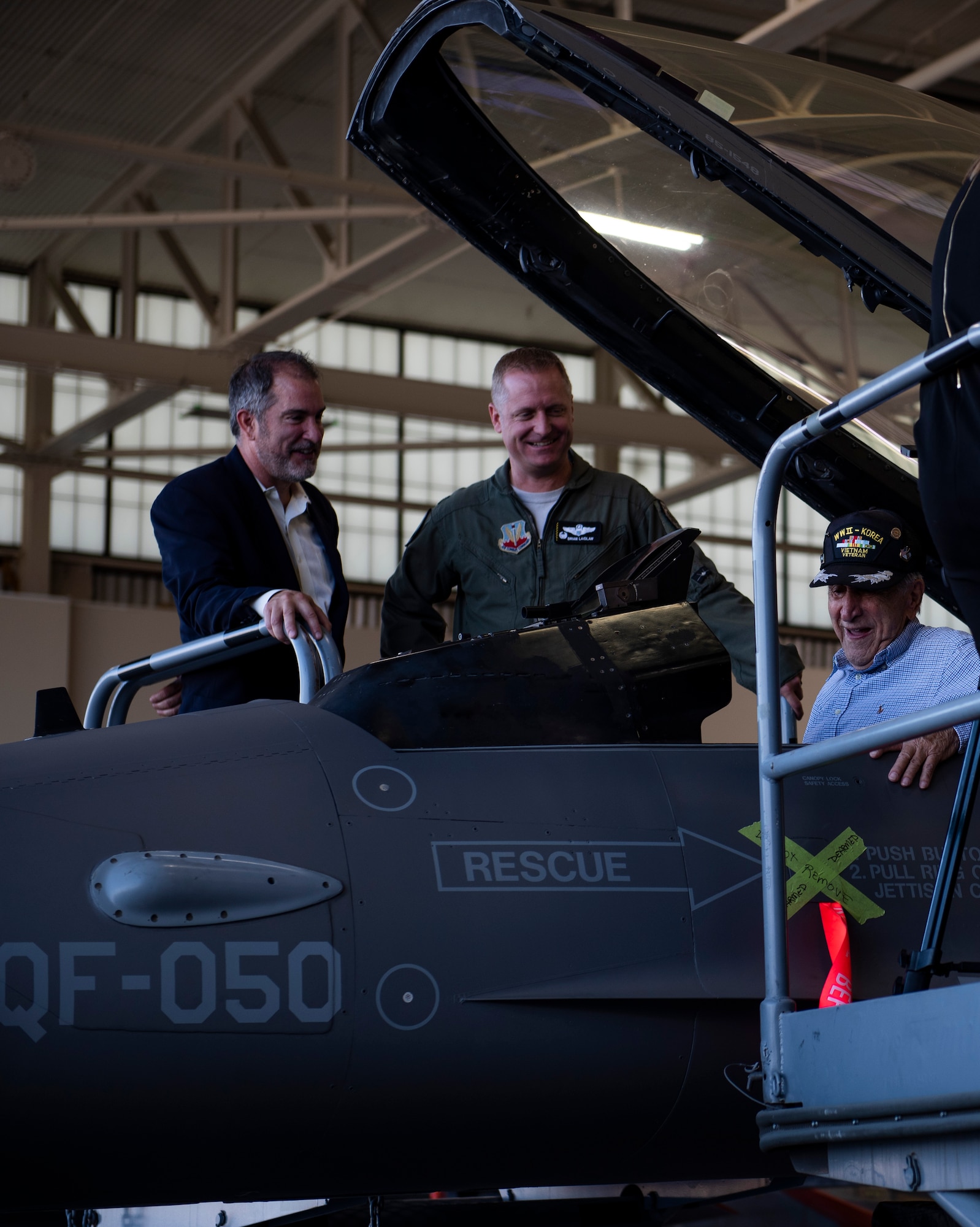 Dr. Daniel Daube, left, U.S. Air Force Col. Brian Laidlaw, 325th Fighter Wing commander, center, and Retired U.S. Air Force Lt. Col. Daniel Daube, right, visited the 325th Fighter Wing and viewed a QF-16 Fighting Falcon at Tyndall Air Force Base, Florida, Nov. 27, 2019. Daube was a veteran of World War II, Korean, and Vietnam war, flying multiple air frames and combat missions. Daube visited a static QF-16 Fighting Falcon and sat in the cockpit for the first time in many years. (U.S. Air Force photo by Staff Sgt. Magen M. Reeves)
