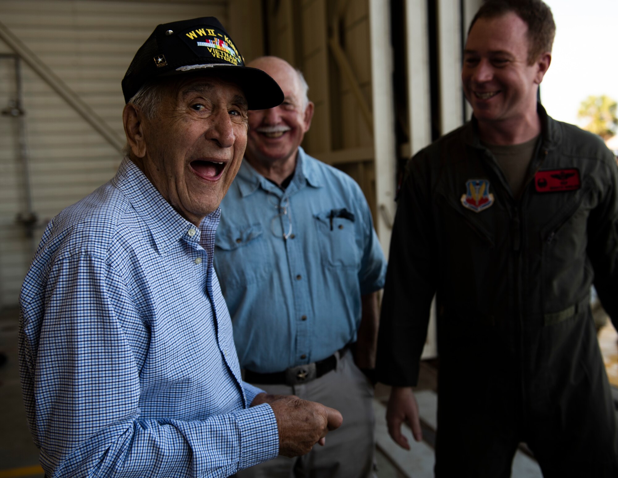 Retired U.S. Air Force Lt. Col. Daniel Daube, left, is coined by U.S. Air Force Lt. Col. Richard Wilson, 325th Operations Support Squadron assistant director of operations, right, at Tyndall Air Force Base, Florida, Nov. 27, 2019. Daube was a veteran of World War II, Korean, and Vietnam war, flying multiple air frames and combat missions. (U.S. Air Force photo by Staff Sgt. Magen M. Reeves)