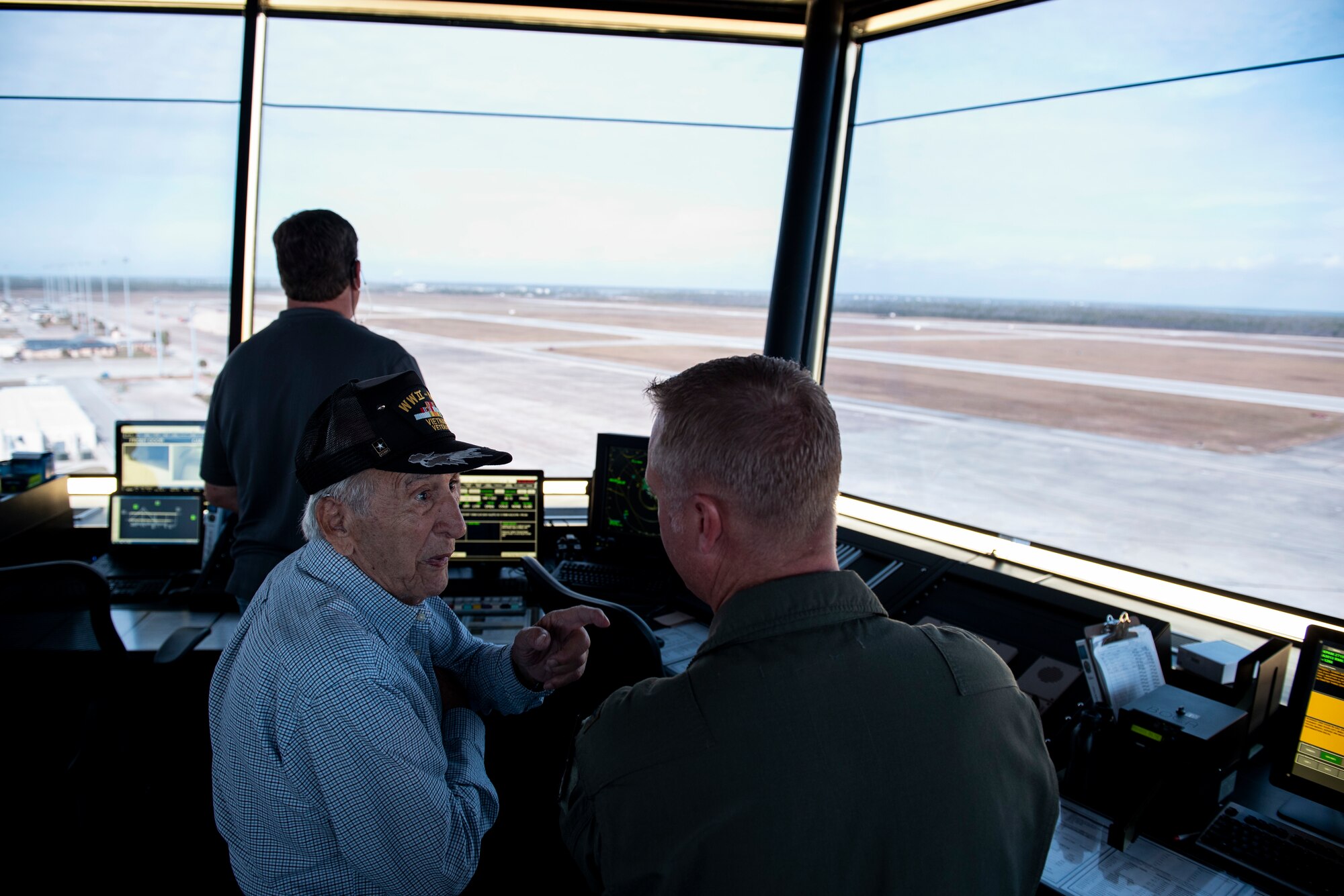 Retired U.S. Air Force Lt. Col. Daniel Daube, left, speaks to U.S. Air Force Col. Brian Laidlaw, 325th Fighter Wing commander, in the air traffic control tower at Tyndall Air Force Base, Florida, Nov. 27, 2019. Daube was a veteran of World War II, Korean, and Vietnam war, flying multiple air frames and combat missions. Daube visited Tyndall's air traffic control tower and saw planes launch off the runway. (U.S. Air Force photo by Staff Sgt. Magen M. Reeves)
