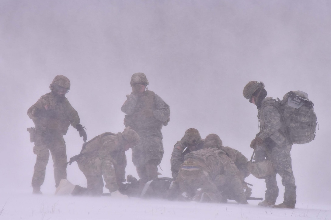 Soldiers train in blowing snow.