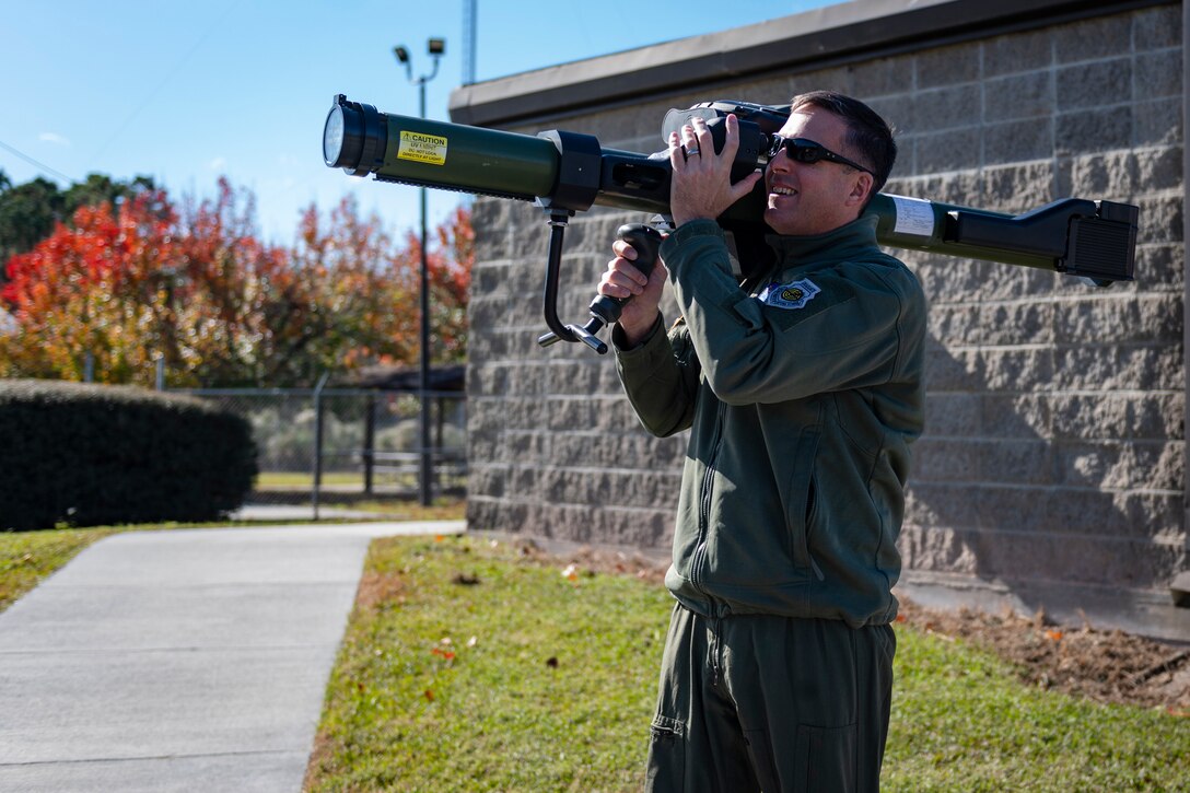 A photo of Col. Dan Walls looking through the sights of an MPAD during a 23d OSS immersion