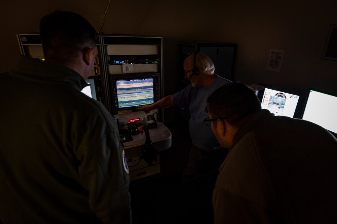 A photo of David Kilmer showing 23d Wing leadership around the scoring room during a 23d OSS immersion