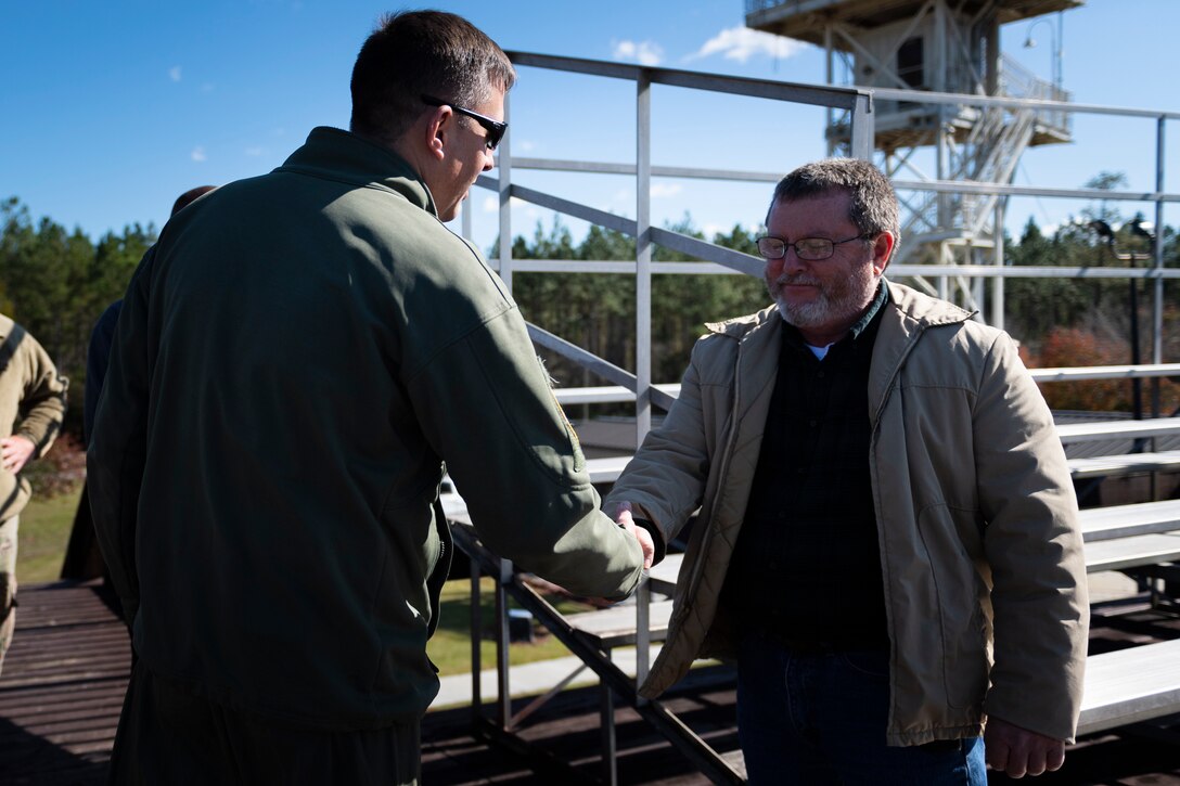 A photo of Col. Dan Walls coining John Bishop during a 23d OSS immersion