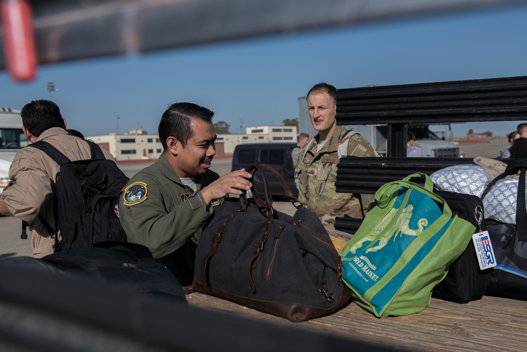 U.S. Air Force Master Sgt. Emmanuel Amigleo, 70th Air Refueling Squadron KC-10 Extender flight engineer, helps a KC-10 crew load their baggage after they return from their deployment Nov. 21, 2019, at Travis Air Force Base, California. The KC-10 crew returned to Travis AFB for the holidays after supporting operations in Southwest Asia for two months. (U.S. Air Force photo by Airman 1st Class Cameron Otte)