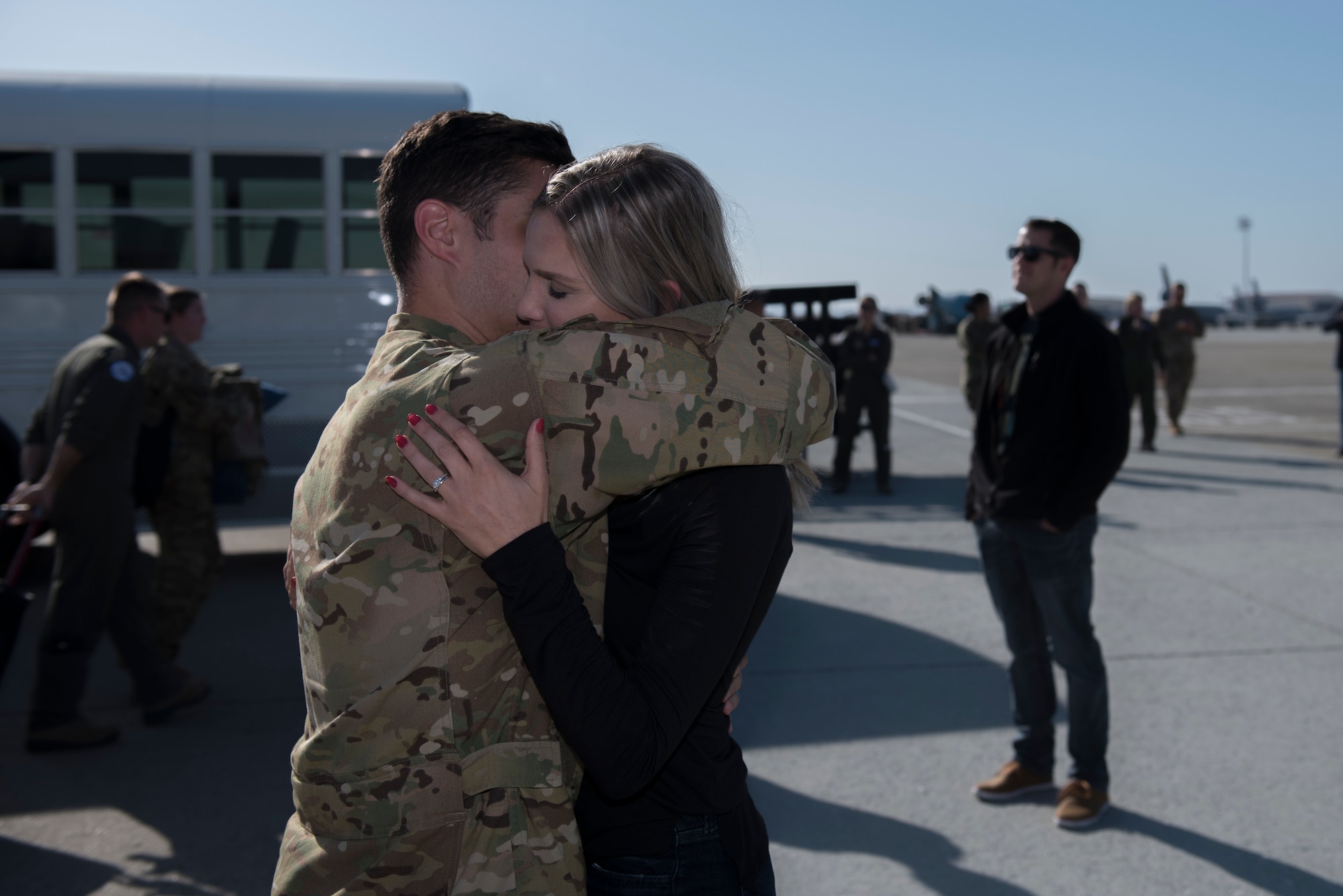 U.S. Air Force Capt. Cory Hume, 6th Air Refueling Squadron assistant flight commander, embraces Jay Hume, his wife, Nov. 21, 2019, at Travis Air Force Base, California. Cory was part of a KC-10 crew that returned to Travis AFB for the holidays after supporting operations in Southwest Asia for two months. (U.S. Air Force photo by Airman 1st Class Cameron Otte)