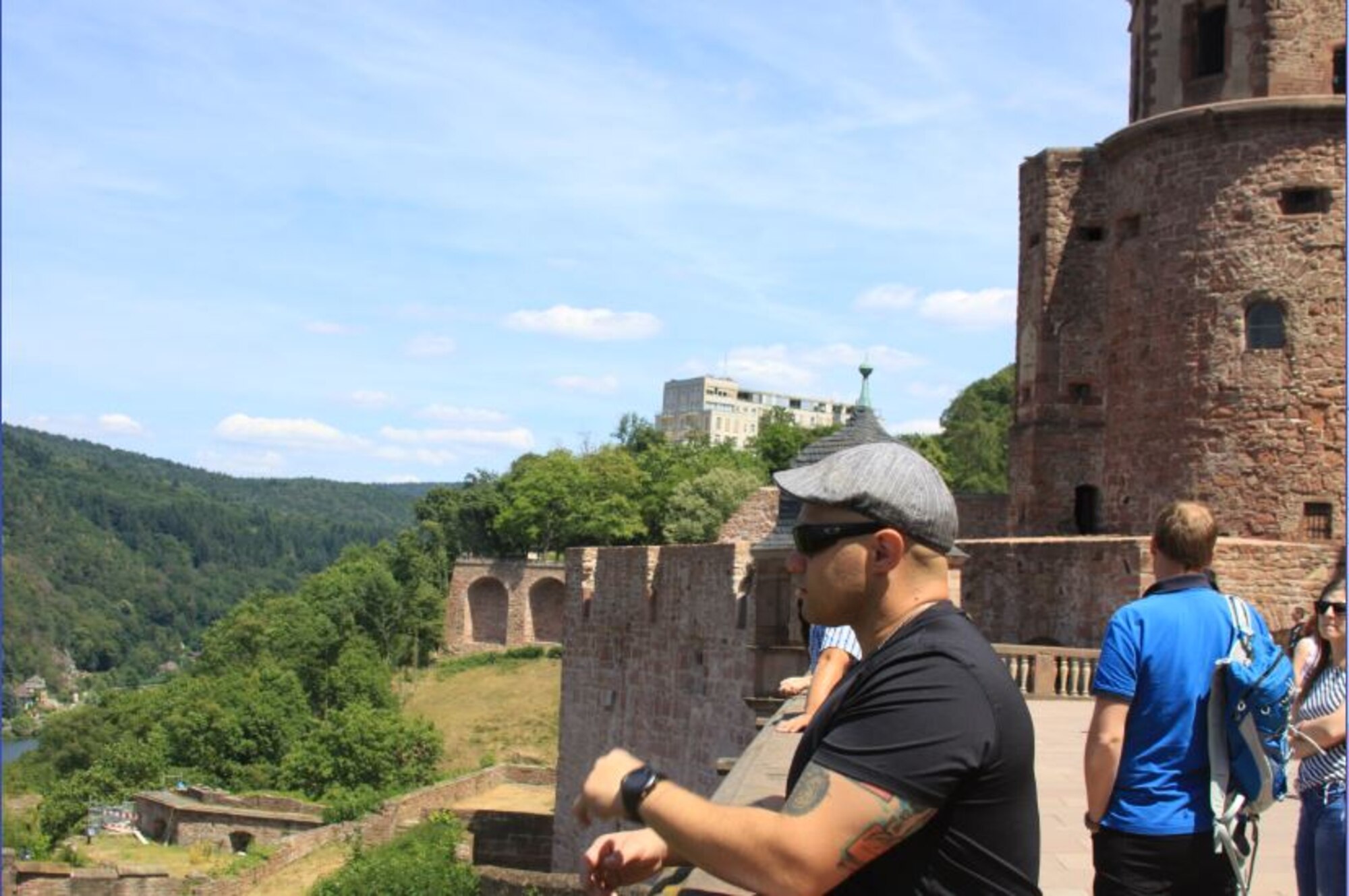 A photo of a man overlooking a wall.