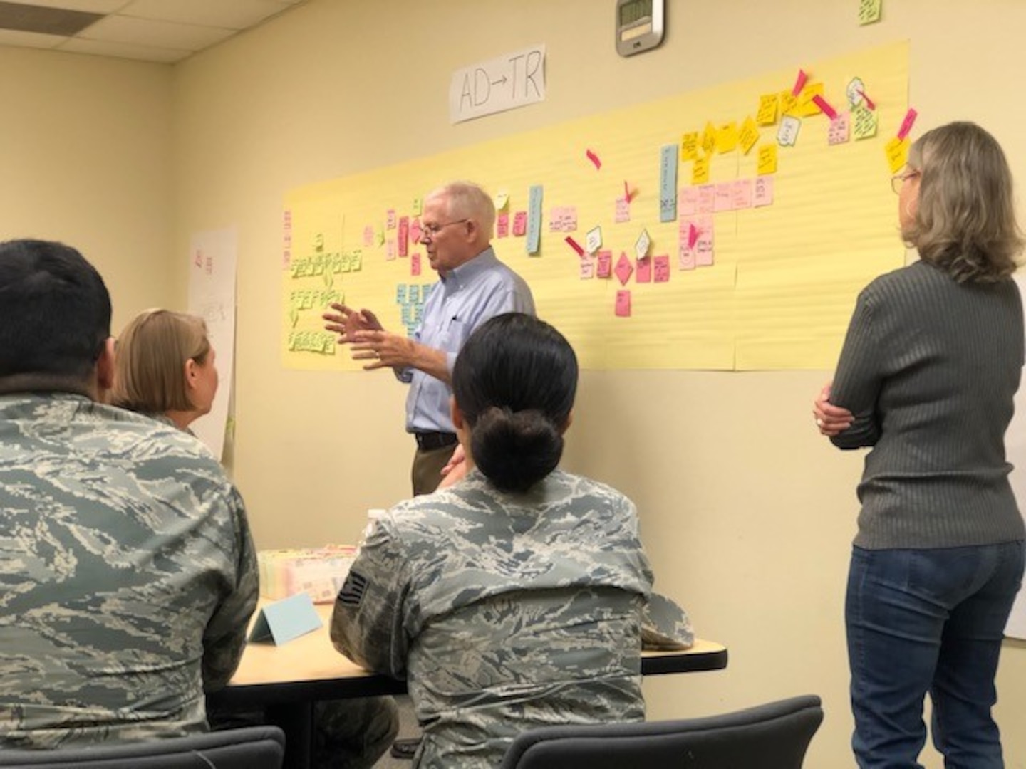 Bob Daffin from the Air Force Reserve Command at Robins Air Force Base, Georgia, offers insights to attendees at the Nov. 19-21 340th Flying Group continuous process improvement event at Joint Base San Antonio-Randolph, Texas, facilitated by his improvement process mentee, Teresa Davies Lt. Col. Sara Linck. The CPI event was held, to find solutions for issues that occur when Reservists transition between pay statuses. (U.S. Air Force photo by Janis El Shabazz)