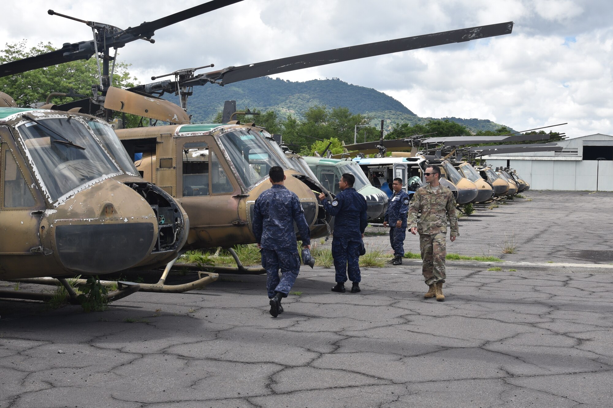 Master Sgt. Raphael Romero, 571st Mobility Support Advisory Squadron aircraft maintenance senior air advisor, inspects the Salvadorian Air Force helicopter boneyard while searching for a trainer model to be used as part of the aircraft maintenance school at Ilopango Air Base, El Salvador. (Courtesy Photo)