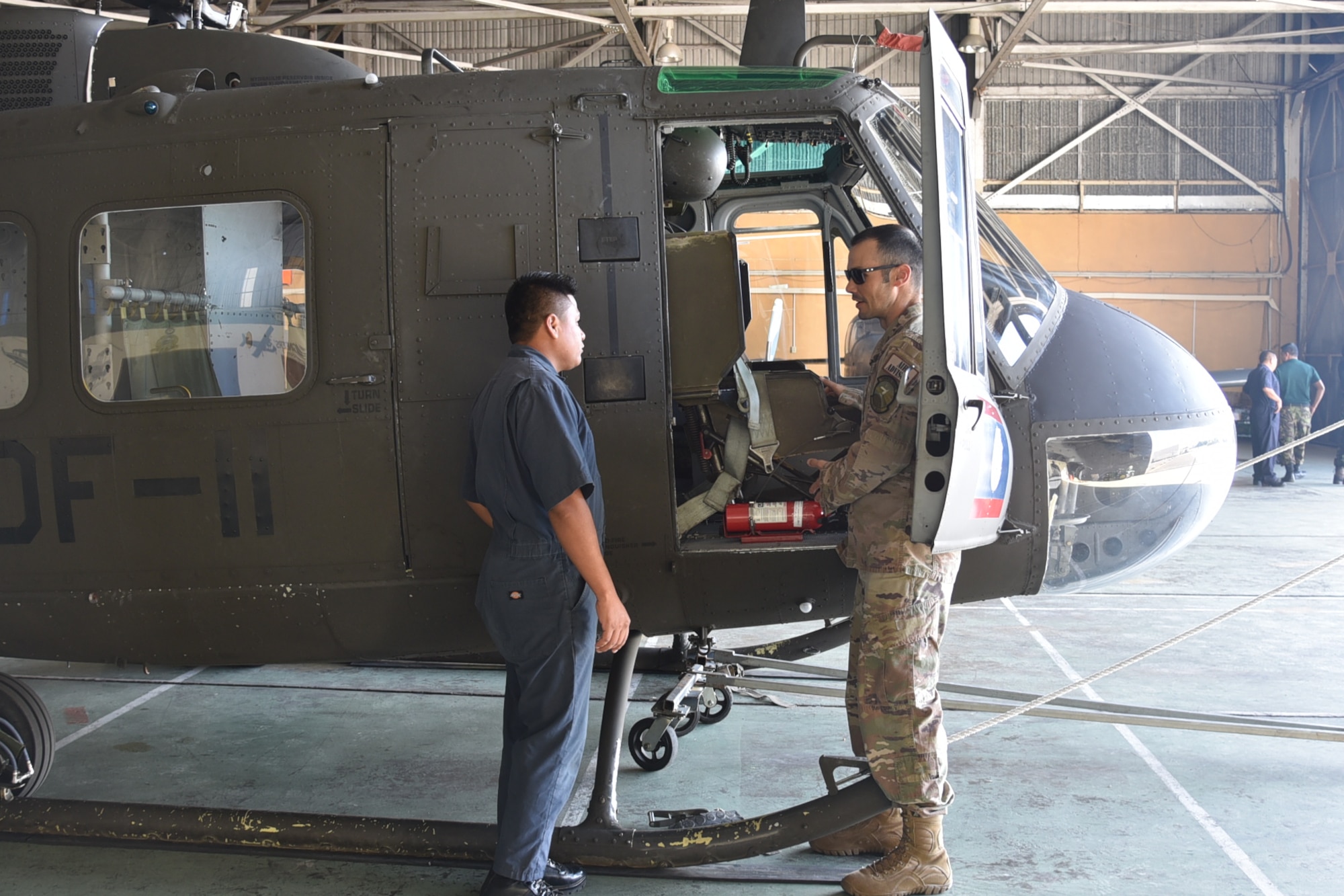 Master Sgt. Raphael Romero, 571st Mobility Support Advisory Squadron aircraft maintenance senior air advisor, instructs a Belizean Defense Force airman on pre-flight inspection at Ladyville, Belize. The MSAS’s training focused on aiding the BDF-AW to increase their capacity to conduct air mobility and transportation operations to improve humanitarian, disaster relief and regional stability operations. (Courtesy Photo)