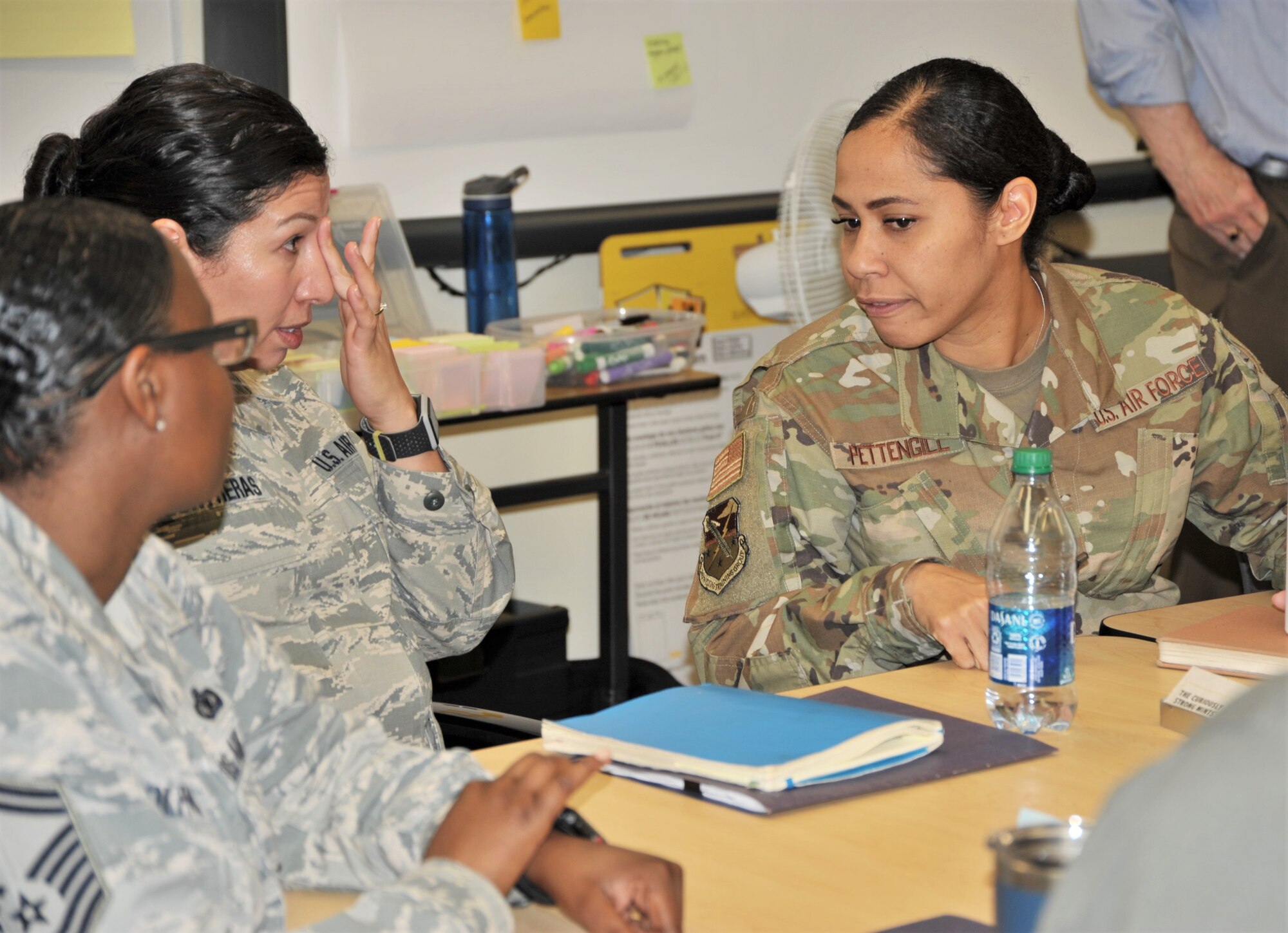 Senior Master Sgt. Tricia Adolphues, 5th Flying Training Squadron personnel superintendent (left), Senior Master Sgt. Vianca Contreras, 97th Flying Training Squadron superintendent and Master Sgt. Tainell Pettengill (right) discuss pay processes at the Nov. 19-21 continuous process improvement event held at Joint Base San Antonio-Randolph, Texa,s to address pay issues that occur when Reserve members transition between pay statuses. (U.S. Air Force photo by Debbie Gildea)