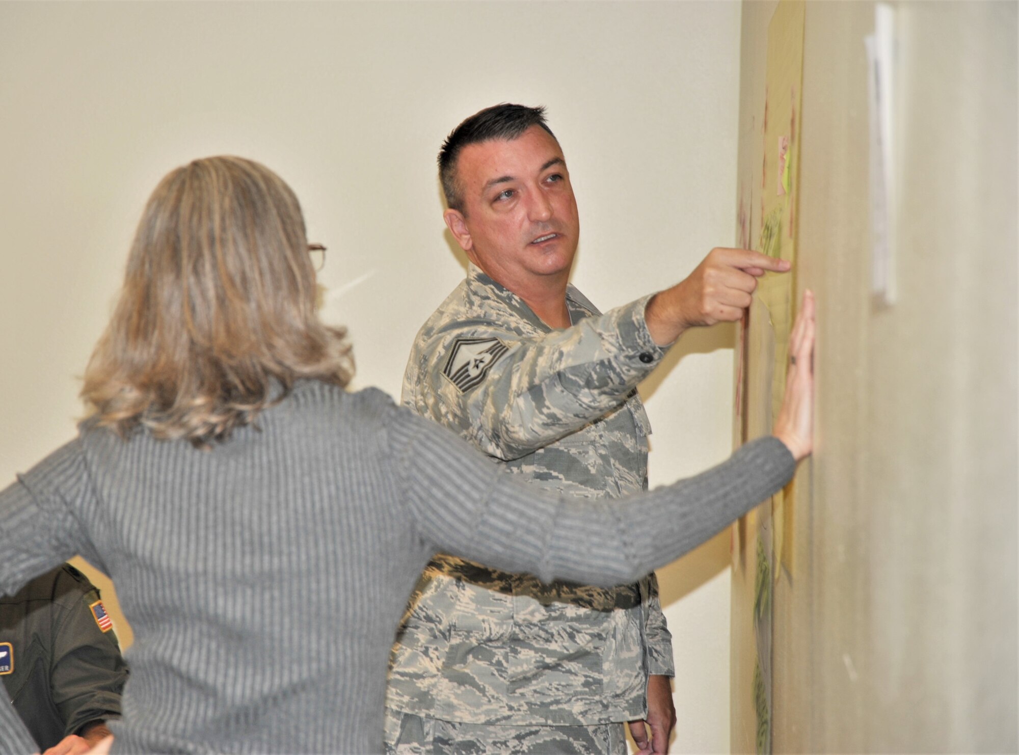 Senior Master Sgt. Jon Rousseaux, 340th Flying Training Group aviation resource management superintendent, discusses Reserve pay processing issues with Teresa Davies, 340th FTG continuous process improvement manager, during the Nov. 19-21 CPI event held at Joint Base San Antonio-Randolph, Texas, to find solutions for issues that occur when Reservist transition between pay statuses while Lt. Col. Brian Boettger, 96th Flying Training Squadron instructor pilot looks on. (U.S. Air Force photo by Debbie Gildea)