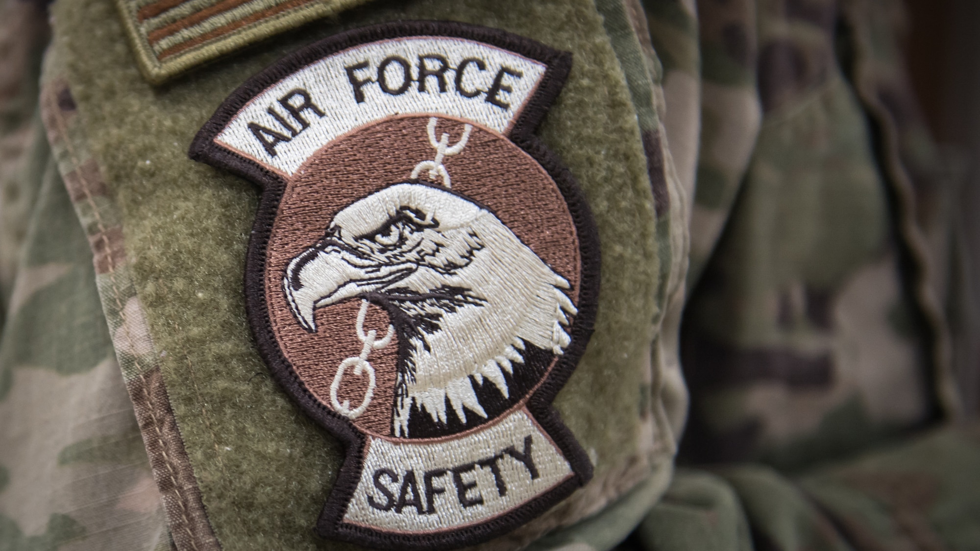 U.S. Air Force Staff Sgt. Courtney Muhl, 386th Air Expeditionary Wing occupational safety NCO-in-charge, dons the Air Force Safety patch at Ali Al Salem Air Base, Kuwait, Nov. 27, 2019. Muhl conducted an annual safety inspection of the clinic ensuring it complied with safety requirements, standards and programs. (U.S. Air Force photo by Tech. Sgt. Daniel Martinez)