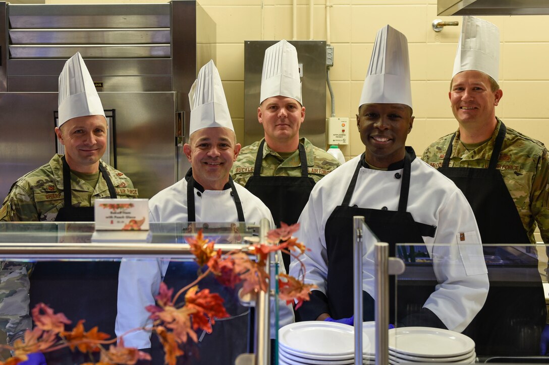 Goodfellow leadership gathers together before serving a Thanksgiving meal at the Western Winds Dining Facility Goodfellow Air Force Base, Texas, Nov. 28, 2019. This tradition is to make sure those who are away from their families still feel like they are a part of one here. (U.S. Air Force photo by Airman 1st Class Zachary Chapman/Released)