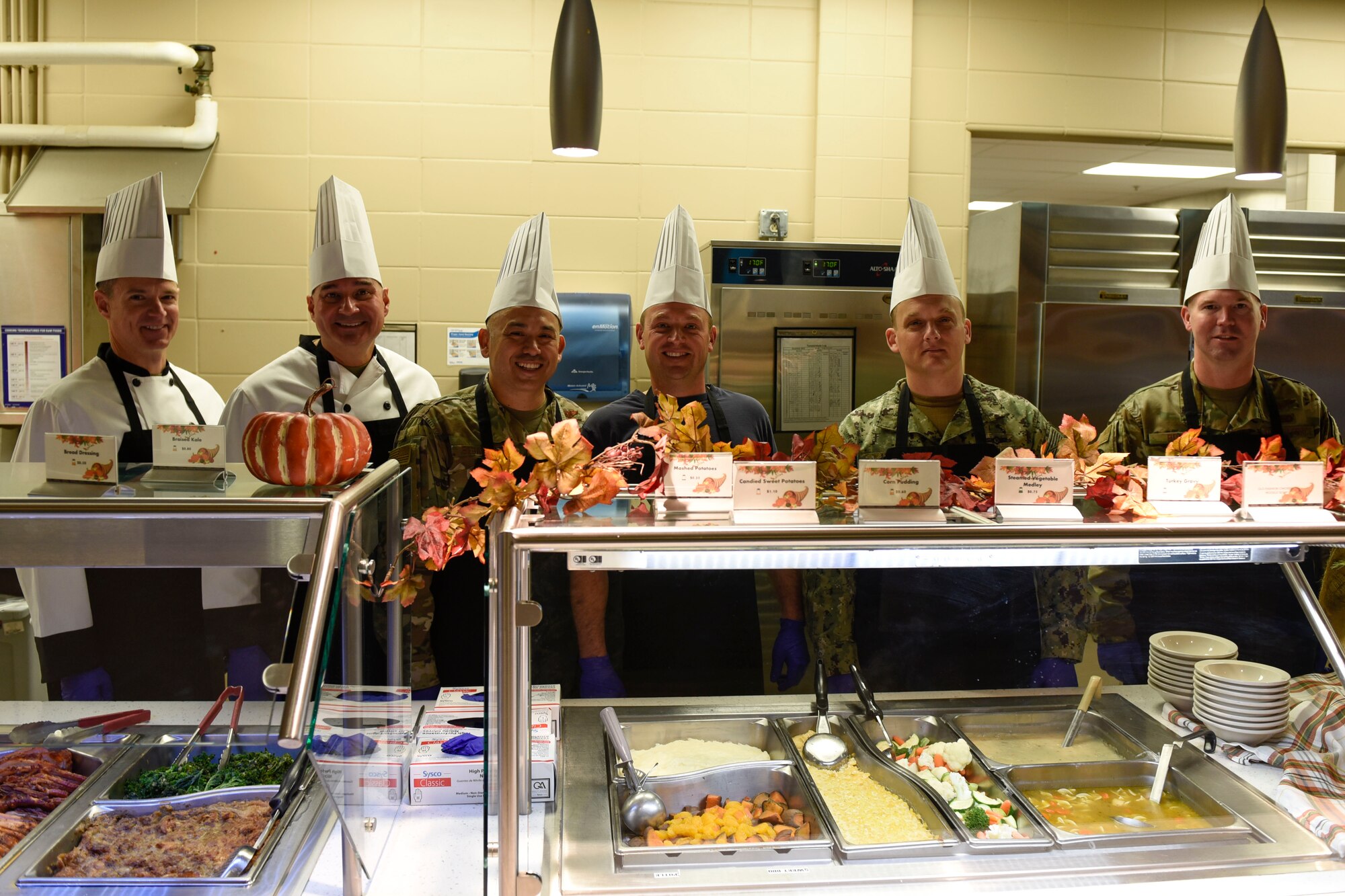 Goodfellow leadership poses before serving a Thanksgiving lunch at the Western Winds Dining Facility Goodfellow Air Force Base, Texas, Nov. 28, 2019. This Thanksgiving meal is a tradition to boost morale for those who cannot spend the day with their families. (U.S. Air Force photo by Airman 1st Class Zachary Chapman/Released)
