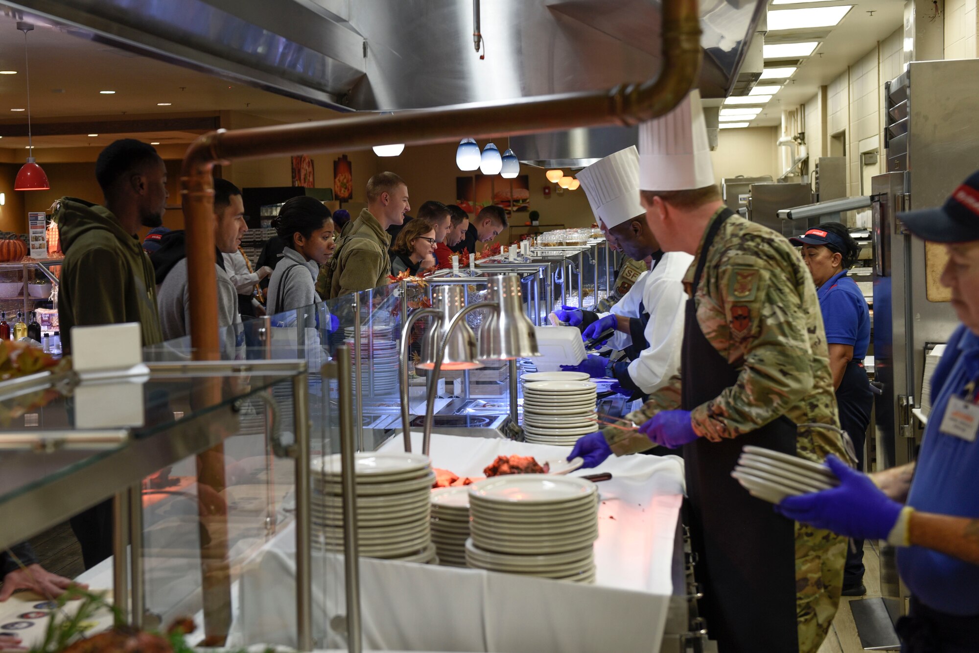 Goodfellow members go through the line to receive a Thanksgiving meal served by leadership at the Western Winds Dining Facility Goodfellow Air Force Base, Texas, Nov. 28, 2019. The meal was open to those who stayed on base over the Thanksgiving break, and family members who came to visit. (U.S. Air Force photo by Airman 1st Class Zachary Chapman/Released)