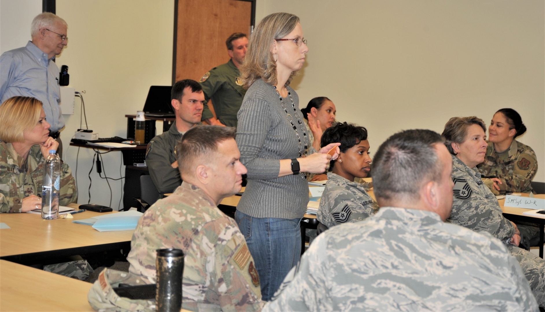 Teresa Davies, 340th Flying Training Group continuous improvement manager, briefs 340th Flying Training Group members gathered at Joint Base San Antonio-Randolph, Texas Nov. 19-21 for a Continuous process improvement event to address pay issues that occur when Reserve members transition between pay statuses as Davies’ improvement process mentor, Bob Daffin from the Air Force Reserve Command at Robins Air Force Base, Ga. looks on. (U.S. Air Force photo by Debbie Gildea)