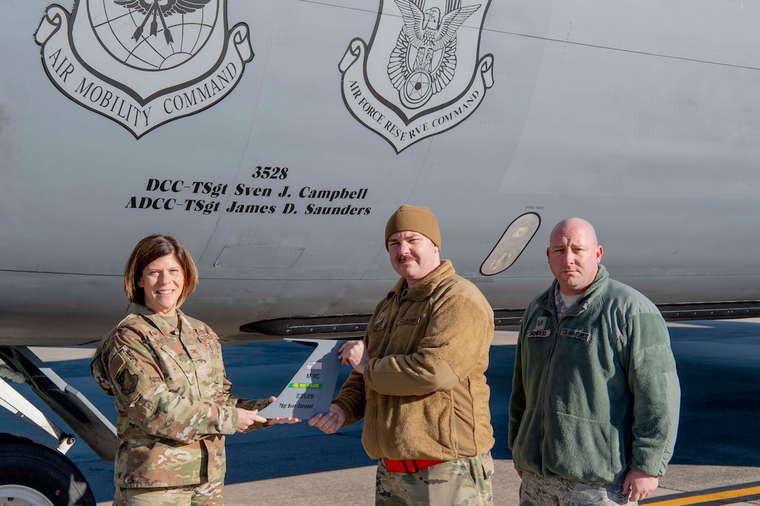 Col Sheets presents a vertical wing stabilizer to the dedicated crew chief of aircraft 3528.