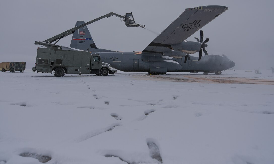 Hercules Airmen de-ice aircraft, re-ice each other