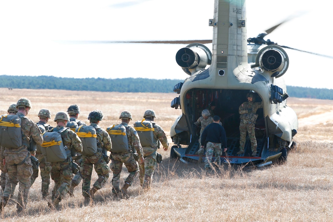 A group of soldiers load into a helicopter.