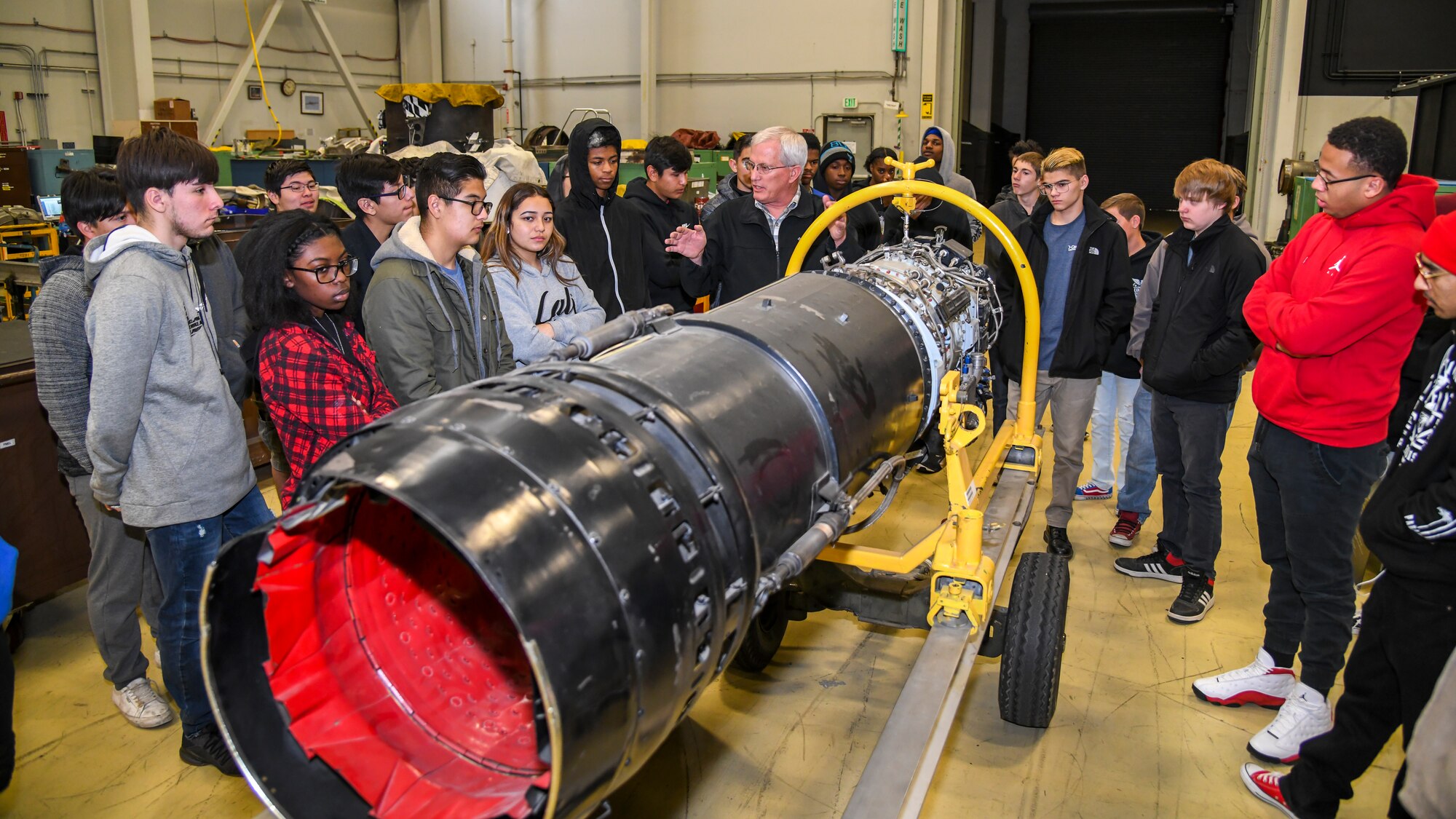 Gregory Peria, Propulsion Production Superintendent, 412th Maintenance Squadron, describes the various components of a jet engine to Victor Valley High School students during their tour of Edwards Air Force Base, California, Dec. 3. The students were members of the high school’s aviation maintenance classes, which include airframe and power plant classes as well as aircraft composite repair and fabrication. (Air Force photo by Giancarlo Casem)