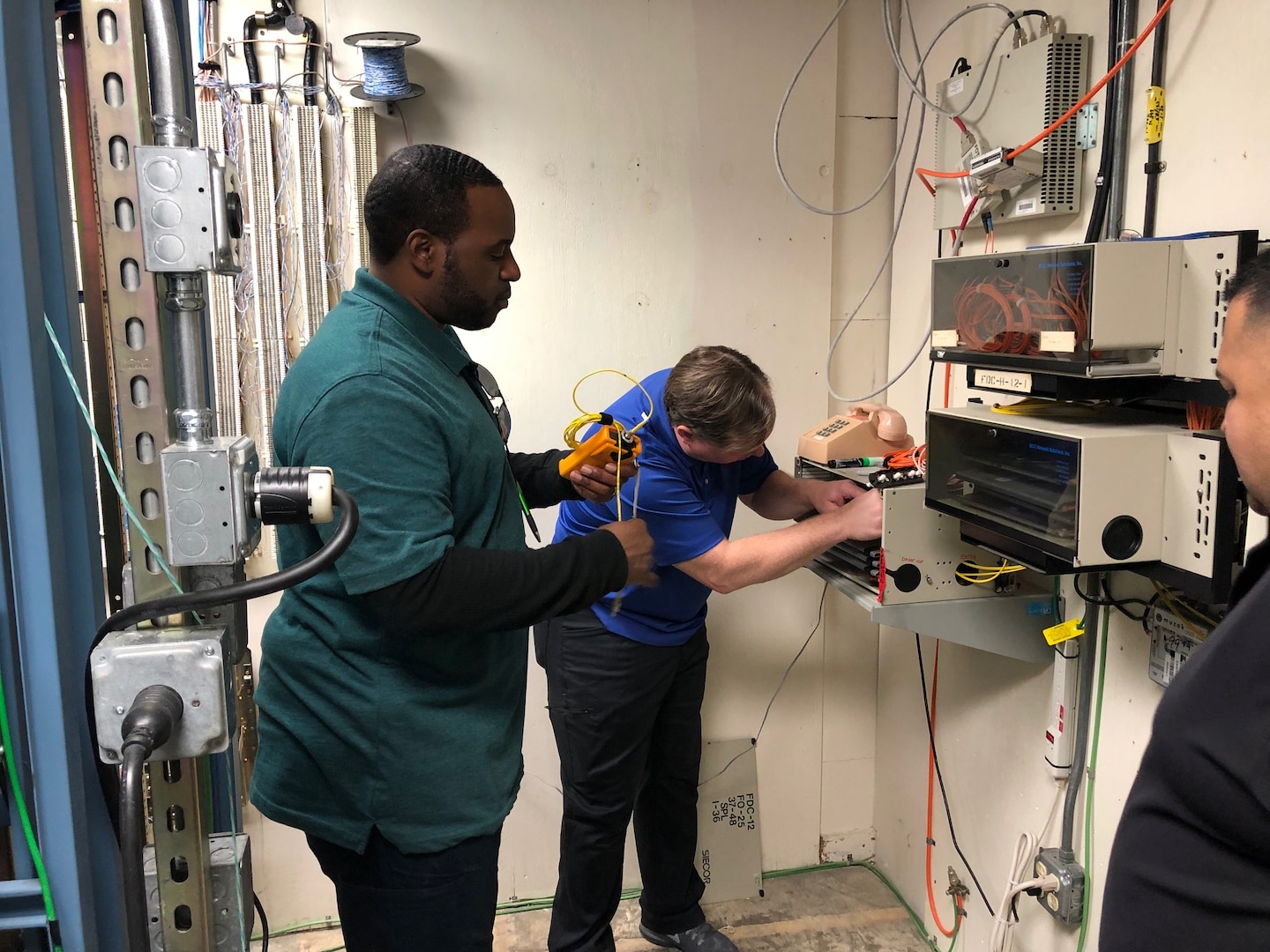 Contractors with the 502nd Communications Squadron install Wi-Fi capability at the 99th Flying Training Squadron at Joint Base San Antonio-Randolph, Texas, Dec. 10, 2018. The Wi-Fi is being installed to offer Airmen in education and training environments a flexible service connectivity option to access or utilize resources such as electronic flight bags, as well as augmented and virtual reality technologies. (U.S. Air Force photo / Dan Hawkins)