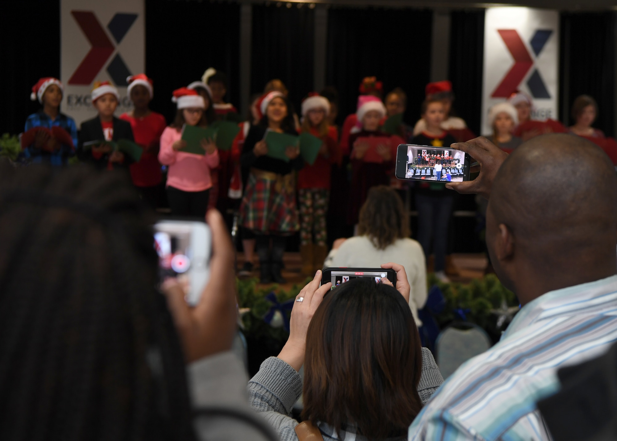 Parents record their children caroling during the Angel Tree Kickoff at Ramstein Air Base, Germany, Dec. 1, 2019. The kickoff included games with prizes, a children’s choir, a guest speaker and free cake. (U.S. Air Force photo by Staff Sgt. Kirby
Turbak)