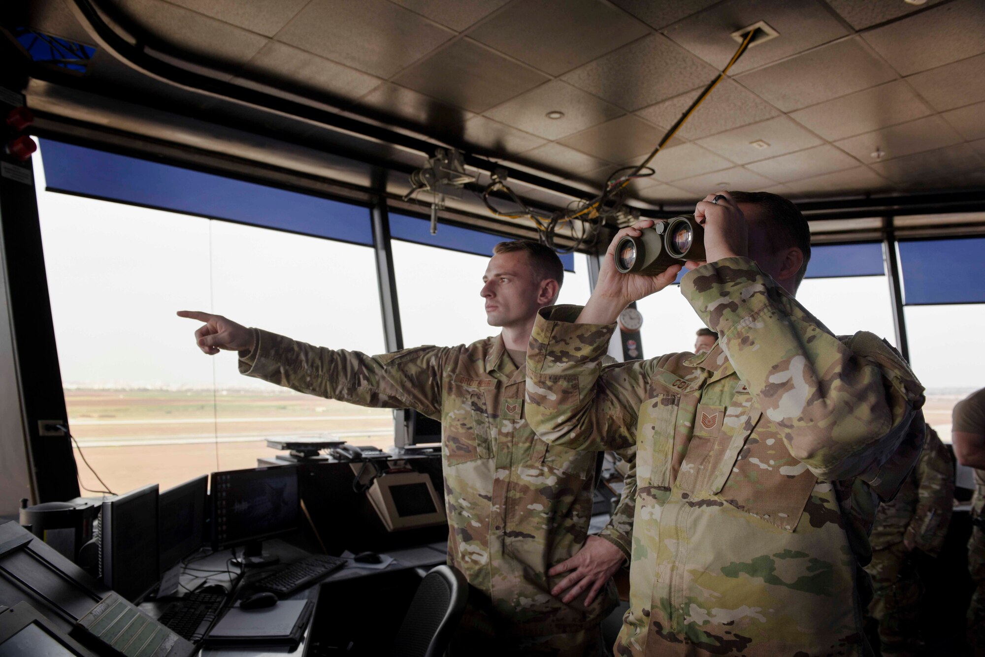 U.S. Air Force Staff Sgt. Garrett Grotheer (left), and Tech. Sgt. Todd Cox, 39th Operation Support Squadron air traffic controllers, monitor the airfield Nov. 25, 2019, at Incirlik Air Base, Turkey. The air traffic control tower and radar approach and control facility work together to ensure the safe direction of traffic in their respective airspaces. (U.S. Air Force photo by Staff Sgt. Joshua Magbanua)