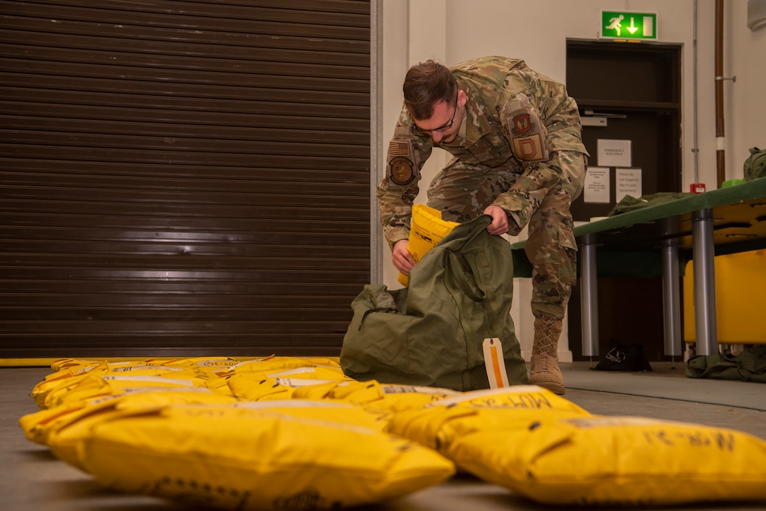 Airman 1st Class Jacob Conn, 100th Operations Support Squadron aircrew flight equipment technician, packs flotation devices at RAF Mildenhall, England, Dec. 3, 2019. Airmen in the AFE shop clean, maintain and repair the equipment aircrew members need to carry out the mission. (U.S. Air Force photo by Airman 1st Class Joseph Barron)