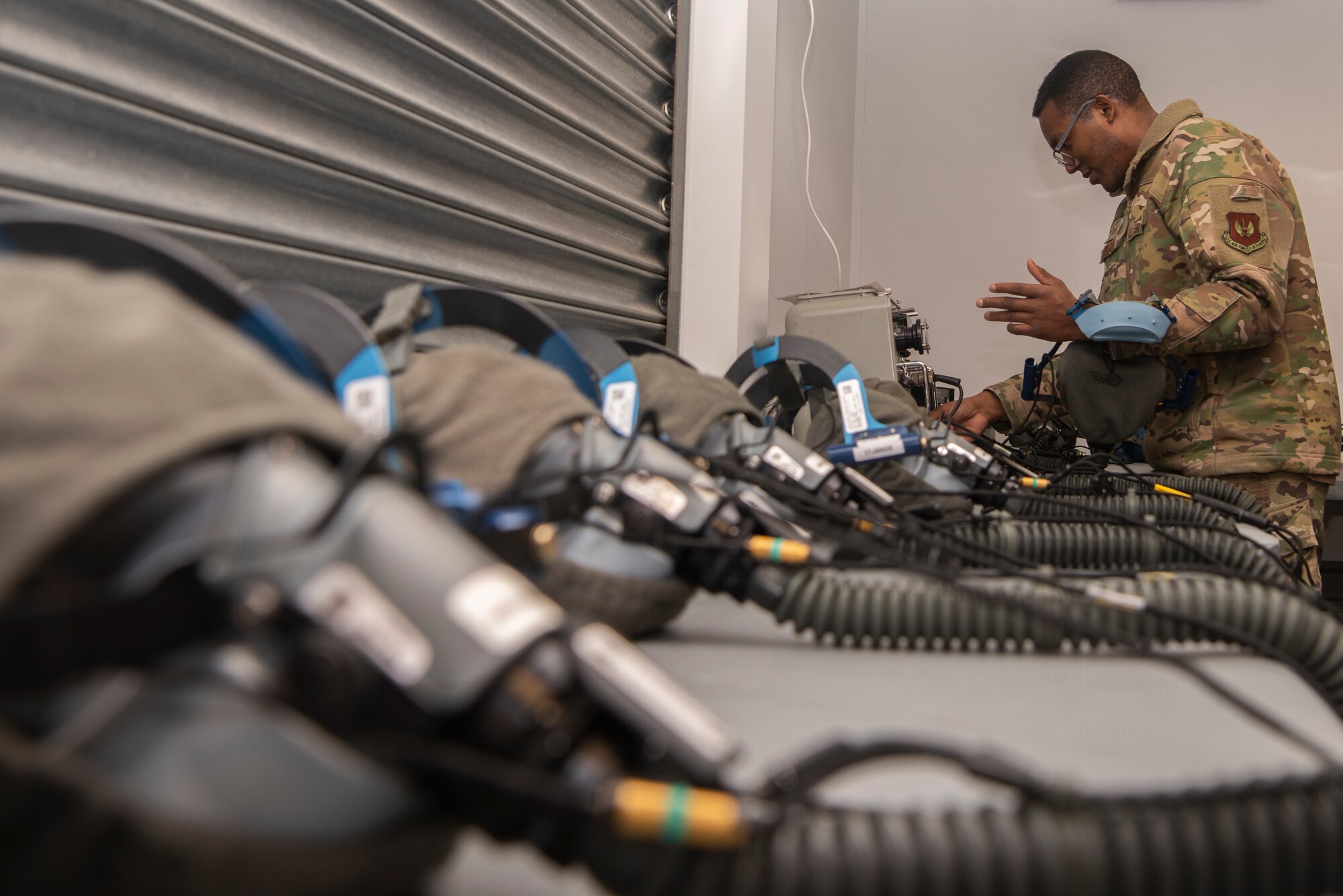 Tech. Sgt. Alexander Johnston, 100th Operations Support Squadron aircrew flight equipment lead trainer, tests a quick-don oxygen mask for functionality at RAF Mildenhall, England, Dec. 3, 2019. The AFE Airmen protect aircrew by ensuring their equipment is operational and free of defects. (U.S. Air Force photo by Airman 1st Class Joseph Barron)