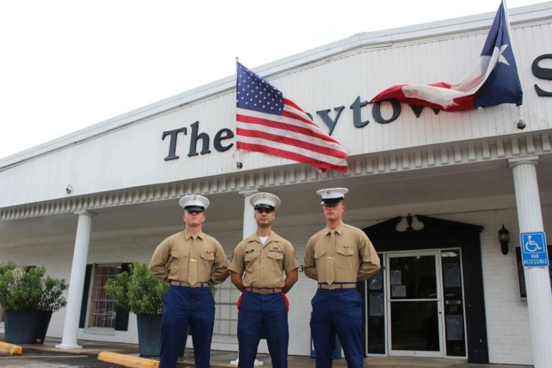 U.S. Marine Corps Pvt. Blake Green, left, SSgt. Baez, middle, and Pvt. Seth Kangas, right, pose for a group photo in front of the Baytown Sun in Houston, Texas.