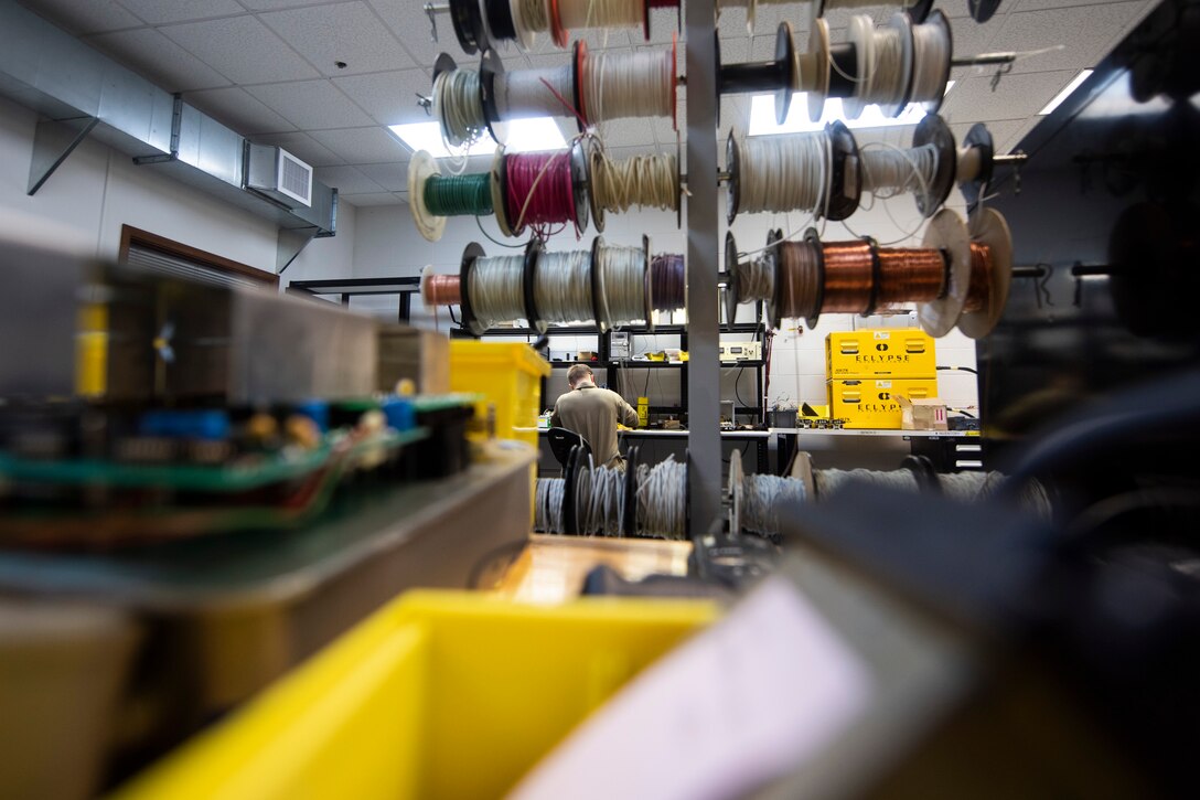 A photo of an Airman preparing to repair a tablet