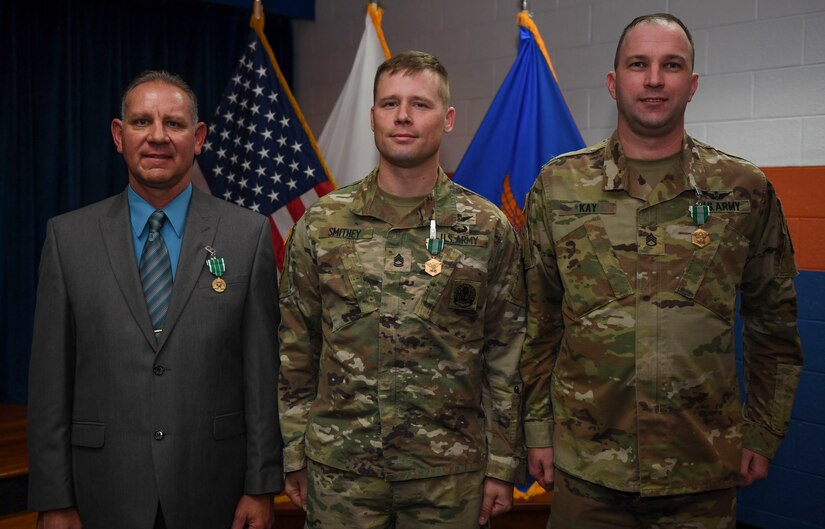 William M. Storrs, Charlie Company, 1st Battalion, 210th Aviation Regiment, 128th Aviation Brigade instructor writer (left), U.S. Army Sgt. 1st Class Daniel Smithey, Charlie Co., 1st Btn., 210th Aviation Regiment, 128th Aviation Brigade avionic mechanic instructor (center), and Staff Sgt. Dennis S. Kay, Bravo Co., 2nd Bte., 210th Aviation Regiment, 128th Aviation Bde. instructor writer (right), pose for a photo during the Instructor of the Year ceremony at Joint Base Langley-Eustis, Virginia, Nov. 21, 2019.