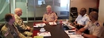 New York National Guard chaplains Maj. Timothy Miller (far left) and Lt. Col. Scott Ehler (left) meet with South African Chief Chaplain Col. R. Stanton, the South African National Defence Force human resources director (center) and South African chaplains Lt. Col. S.E.E. Loate and  Col. Z.A. Makalima in Pretoria, South Africa, Nov. 25, 2019. The New York National Guard and the South African National Defence Force have had a National Guard State Partnership Program relationship since 2003.