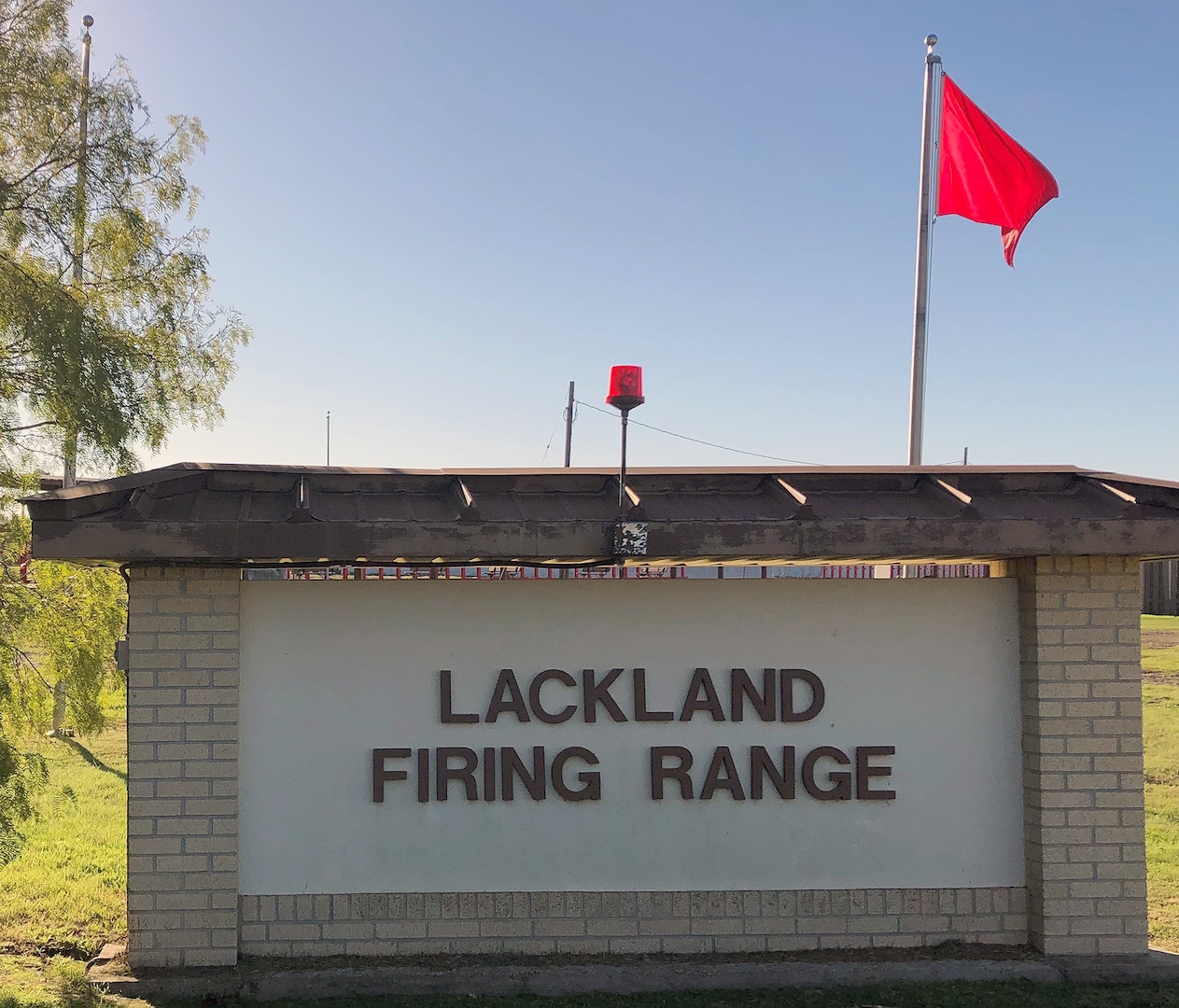 The display of a red flag and/or a rotating red beacon is located at each range entry point at the JBSA-Lackland Medina Annex range. The rotating red beacon is used during night firing. This flag or beacon indicates the range complex is in operation and firing is scheduled.